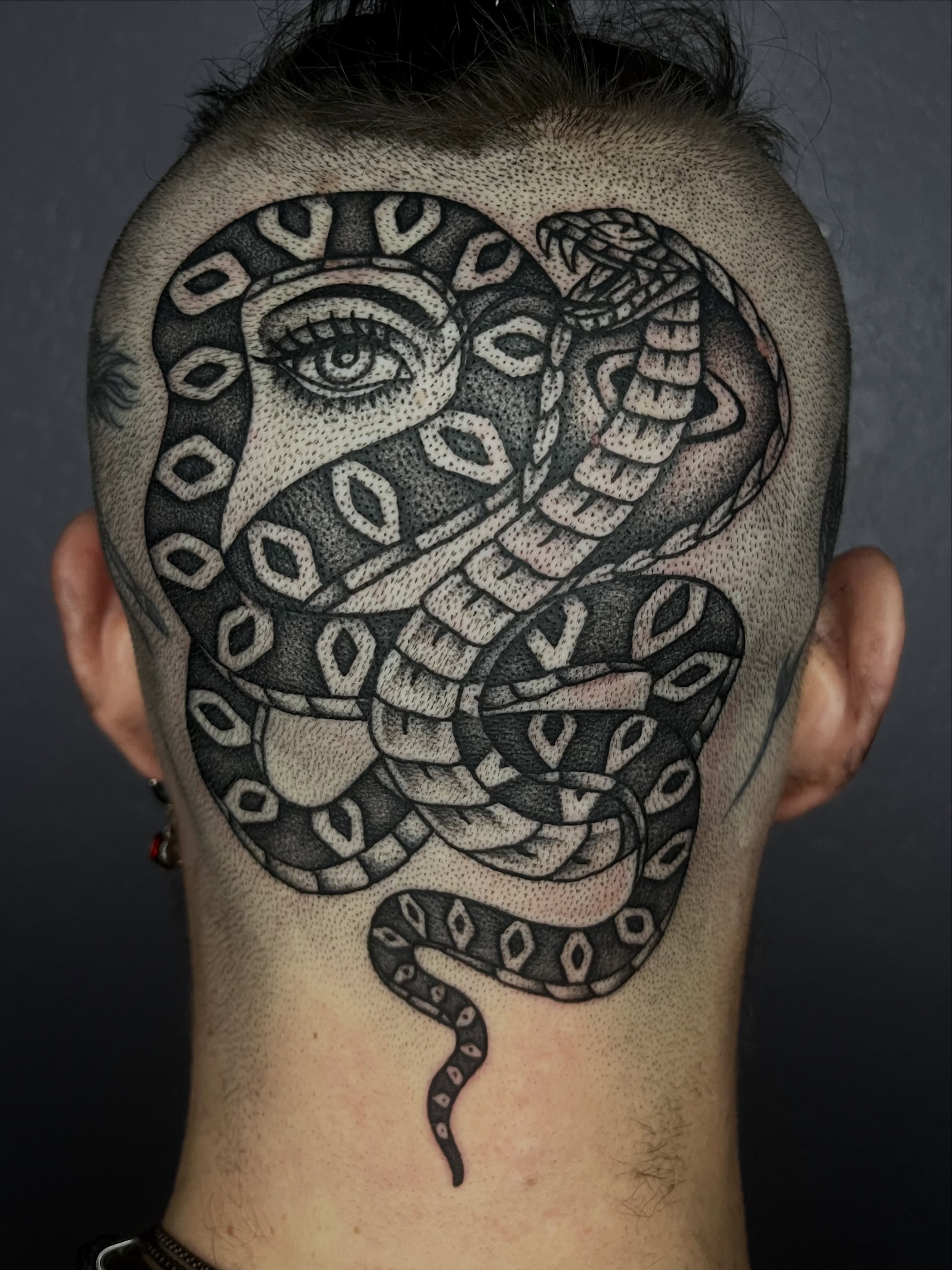 Snake dotwork tattoo on the head by Patrick Elijah