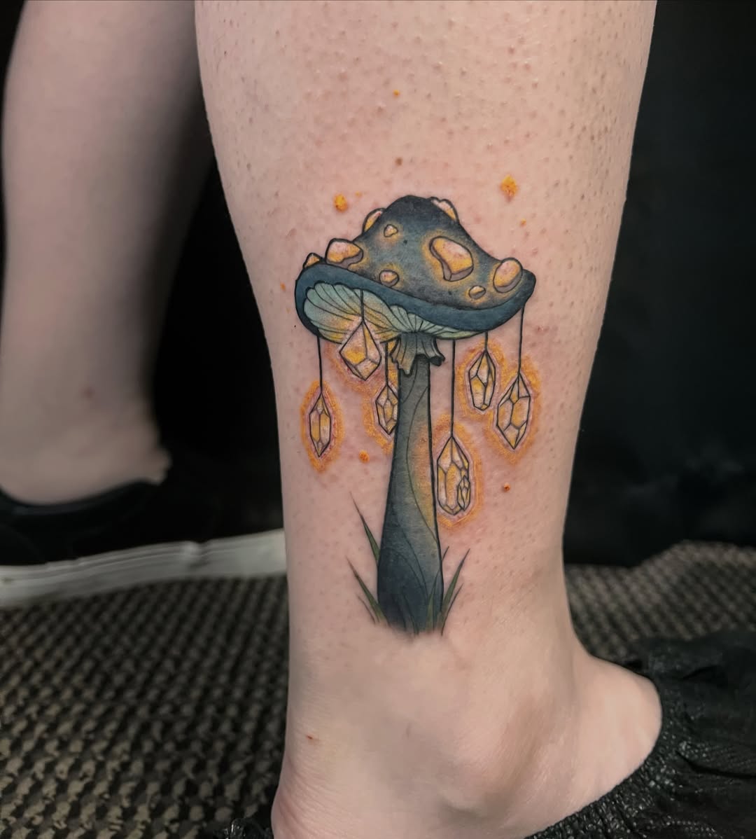 Mushroom with crystals watercolor tattoo on the calf by Wren Hollow, Portland, Oregon