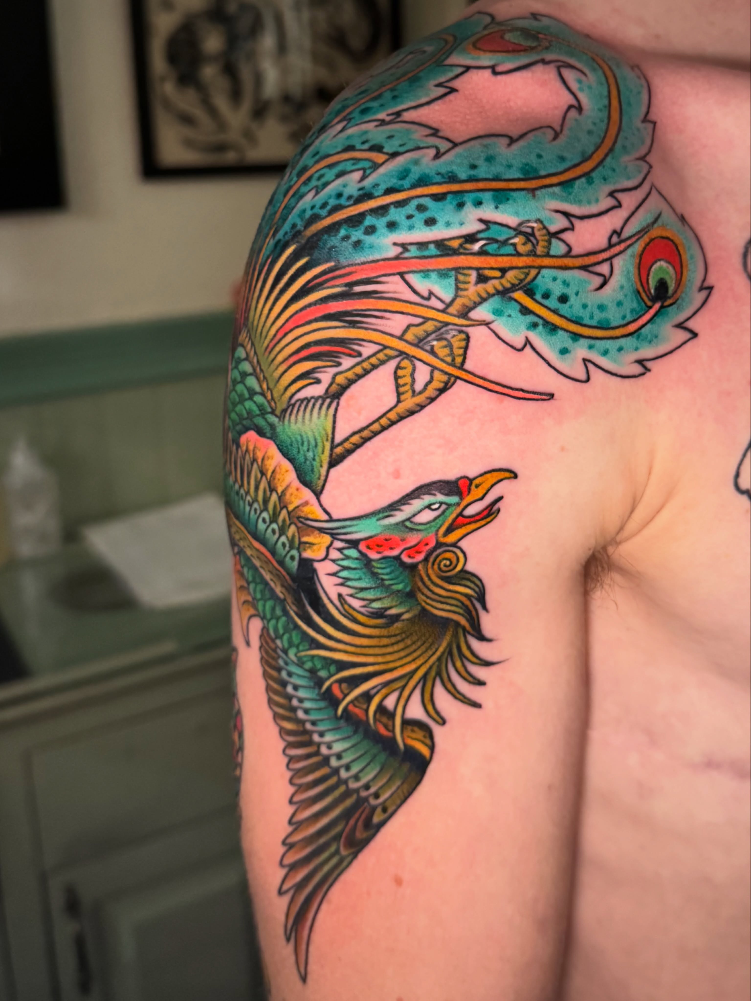 Phoenix American traditional tattoo on the shoulder by Pavel