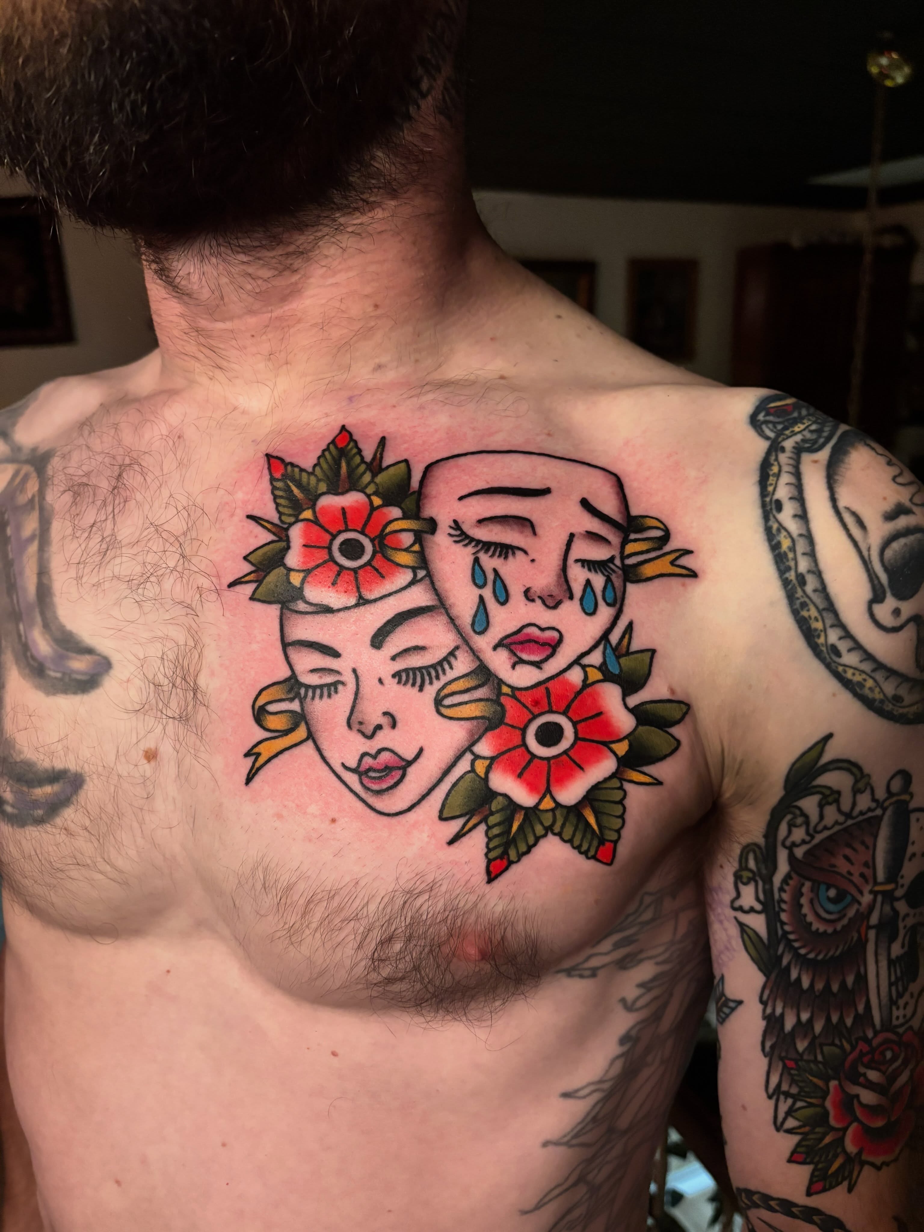 Dual faces with flowers American traditional tattoo on the chest by Tyler Whalen