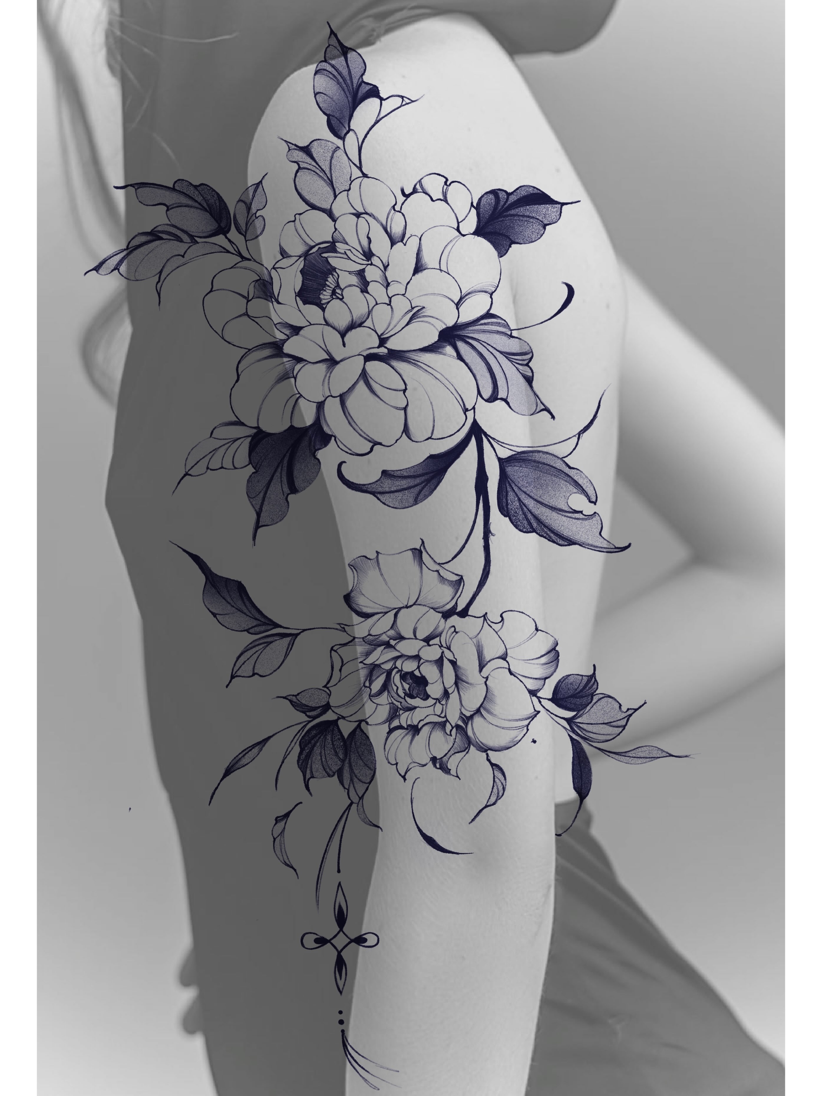Floral bouquet black and grey tattoo on the upper arm by Jinz