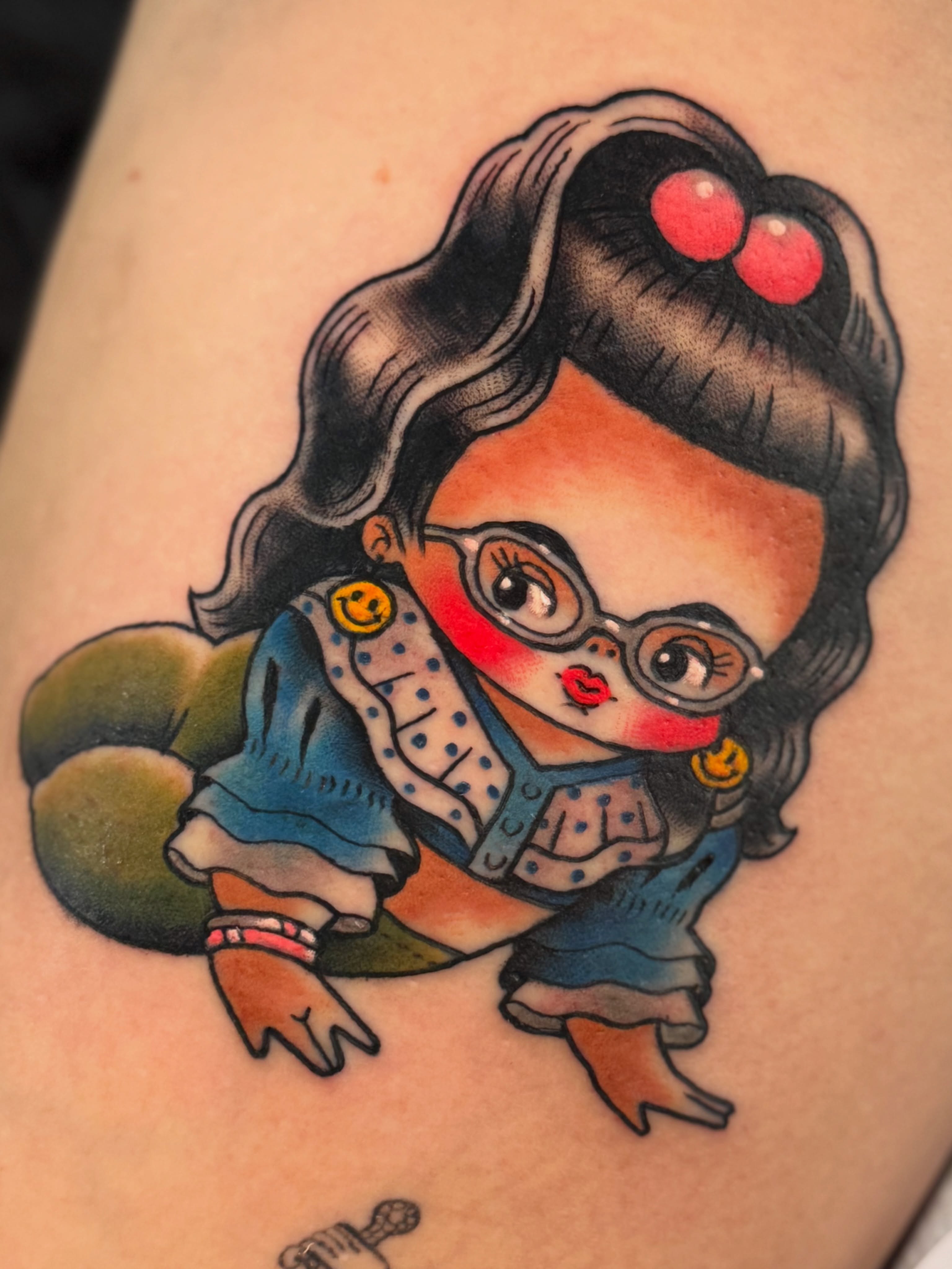 Girl with glasses American traditional tattoo on the upper arm by Stacey Martin Smith