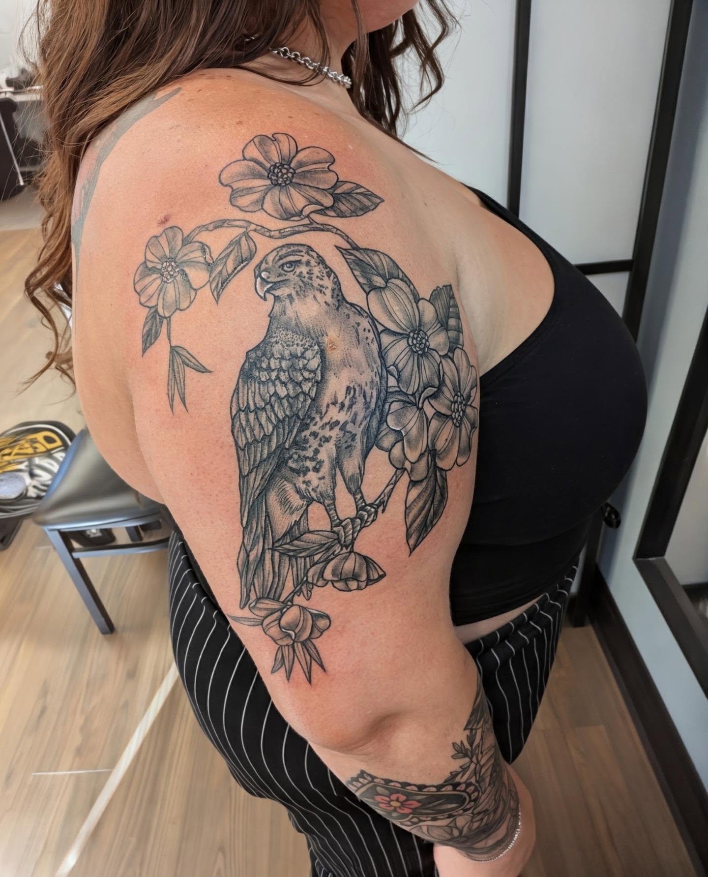 Hawk and flowers black and grey tattoo on the shoulder by Devon Ward, Portland, Oregon