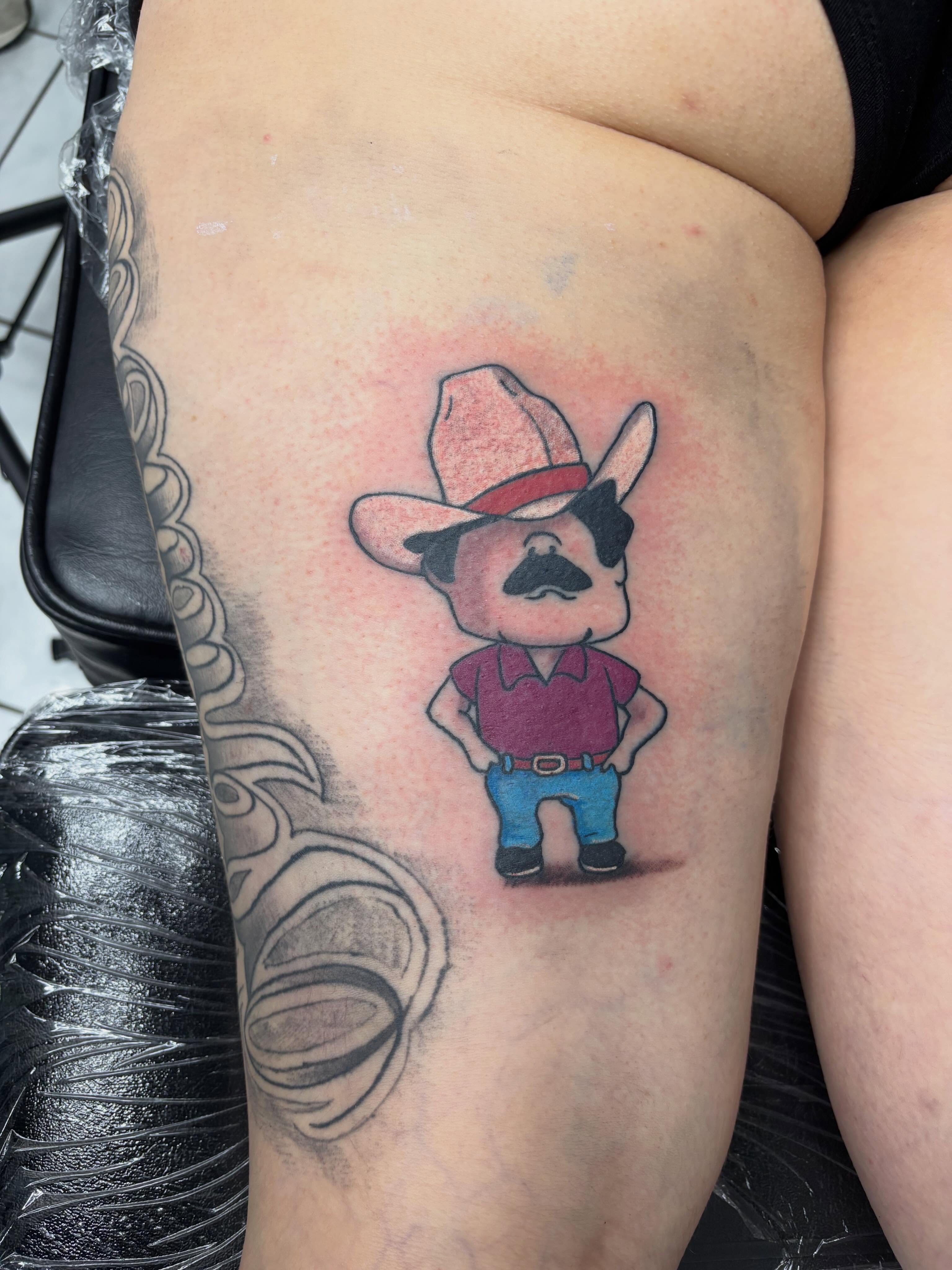 Cowboy character American traditional tattoo on the thigh by Shadows Tattoos