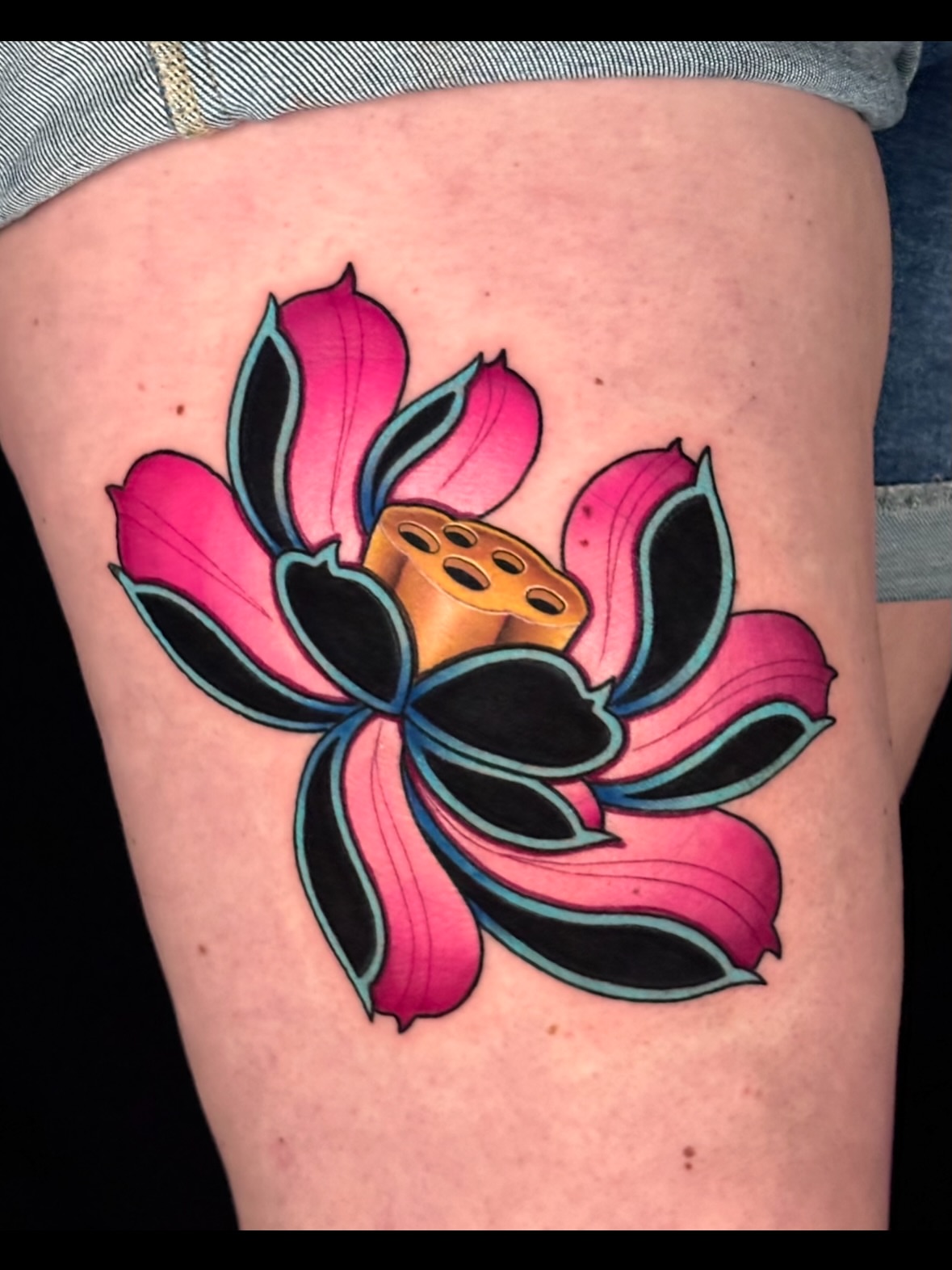Lotus flower American traditional tattoo on the thigh by Chi, Charlotte, North Carolina