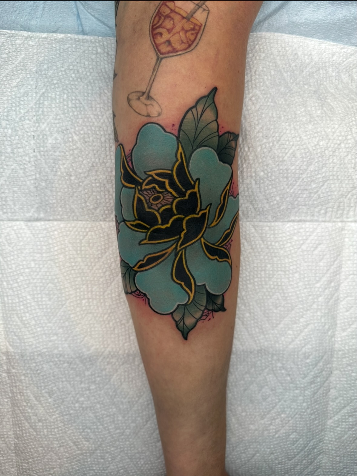 Flower American traditional tattoo on the forearm by Chi, Charlotte, North Carolina