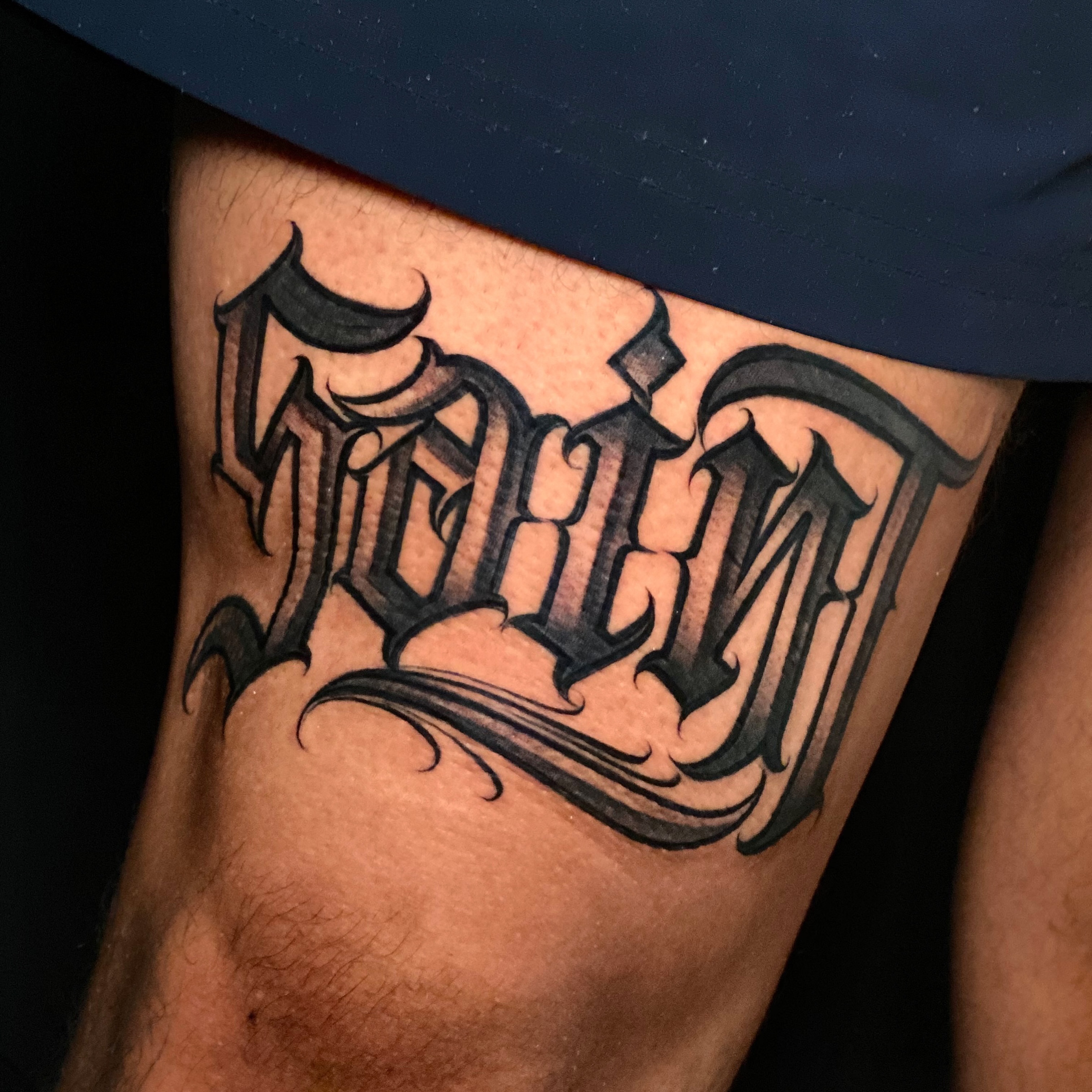Script lettering lettering script tattoo on the thigh by Flames, Cerritos, California