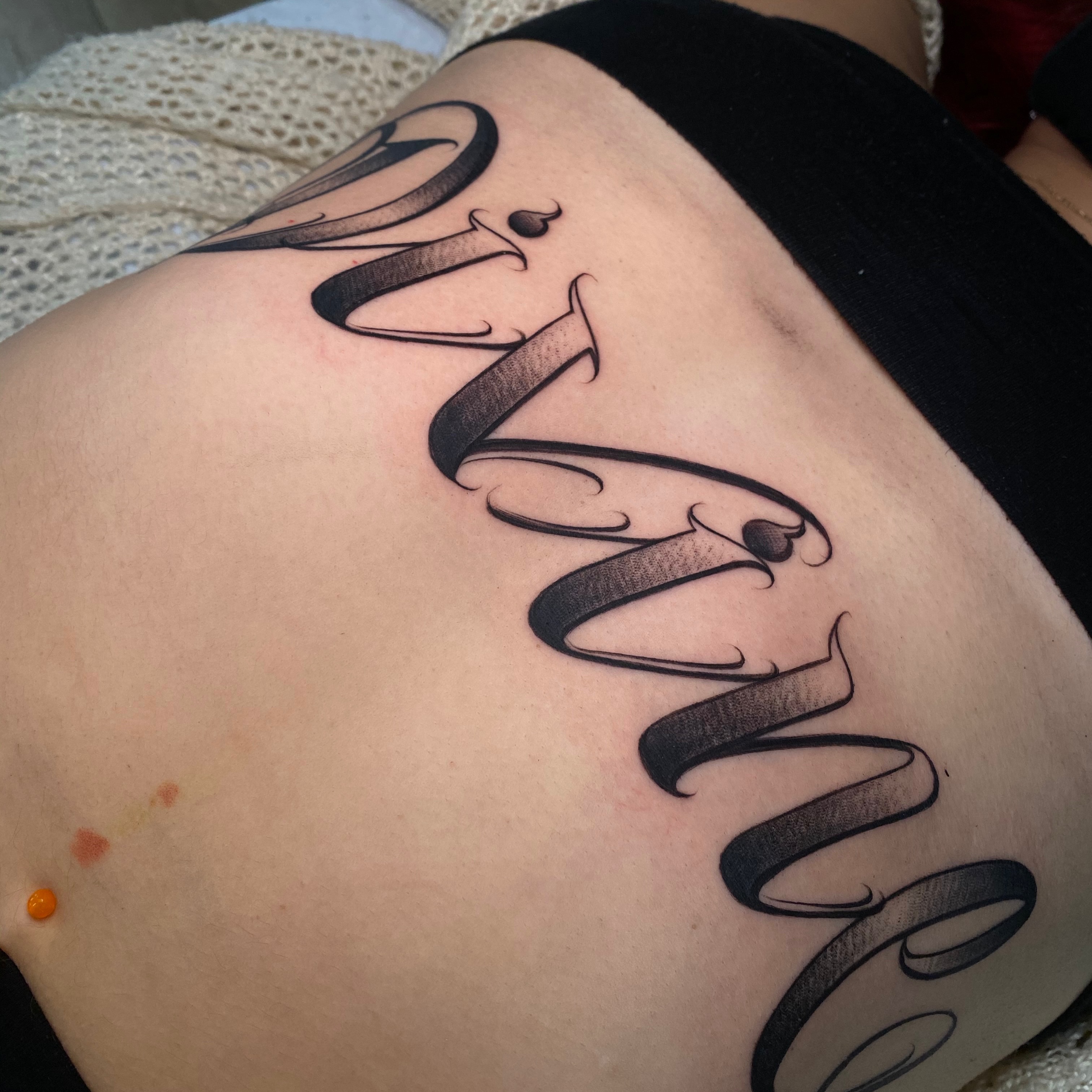 Script lettering lettering script tattoo on the thigh by Flames, Cerritos, California