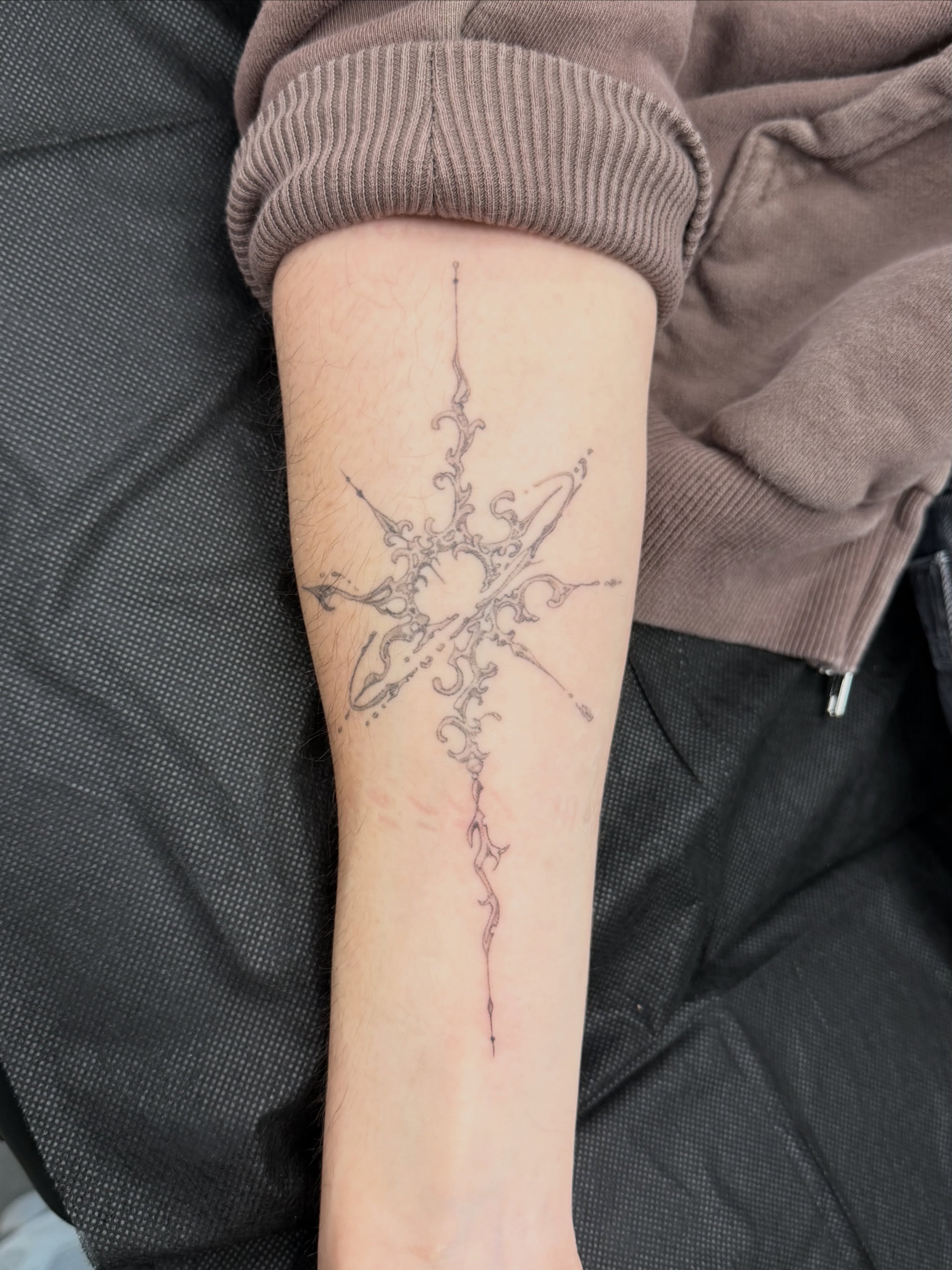 Cross ornamental tattoo on the forearm by Anna