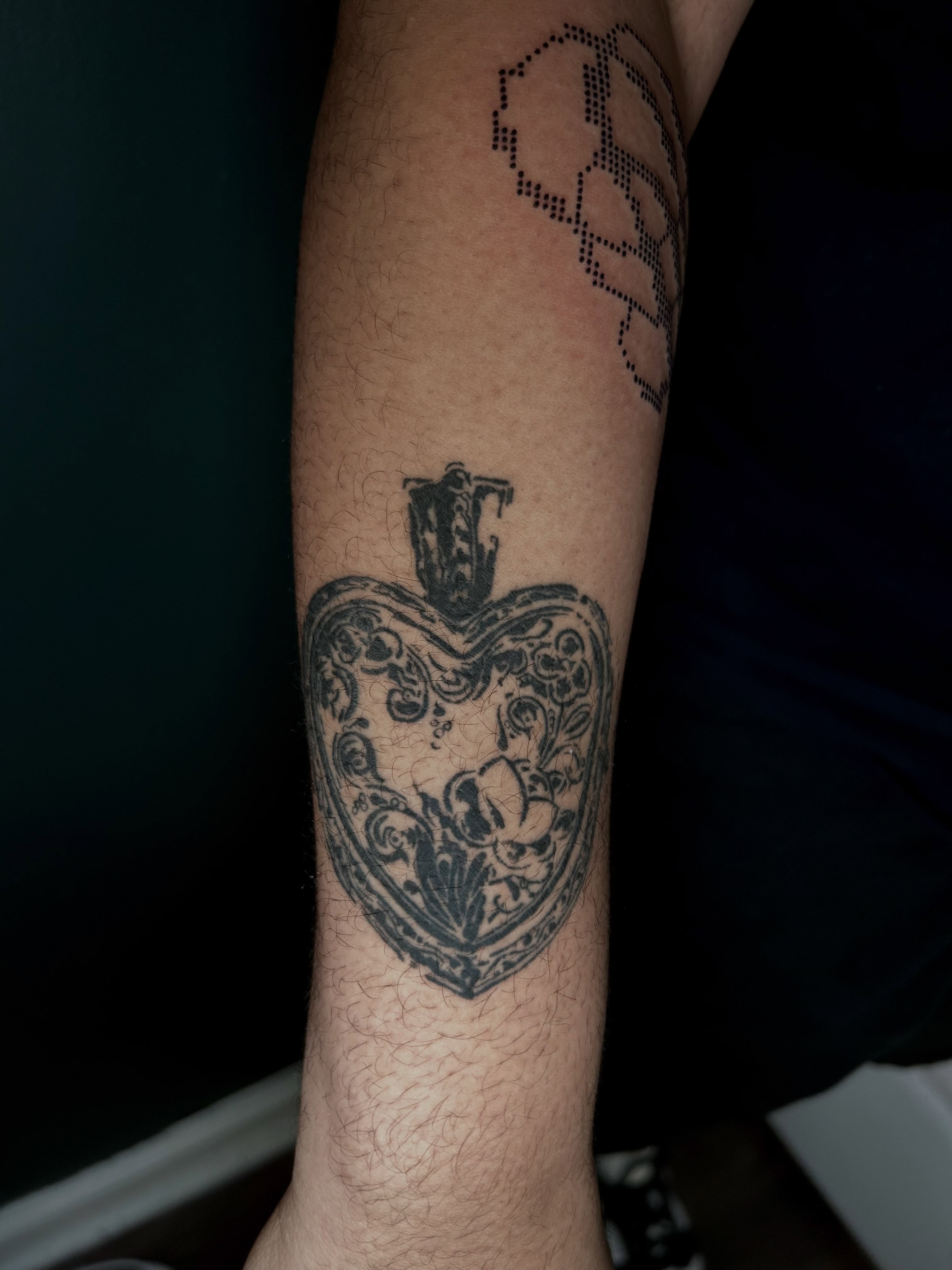 Heart with floral ornamentation black and grey tattoo on the forearm by KB