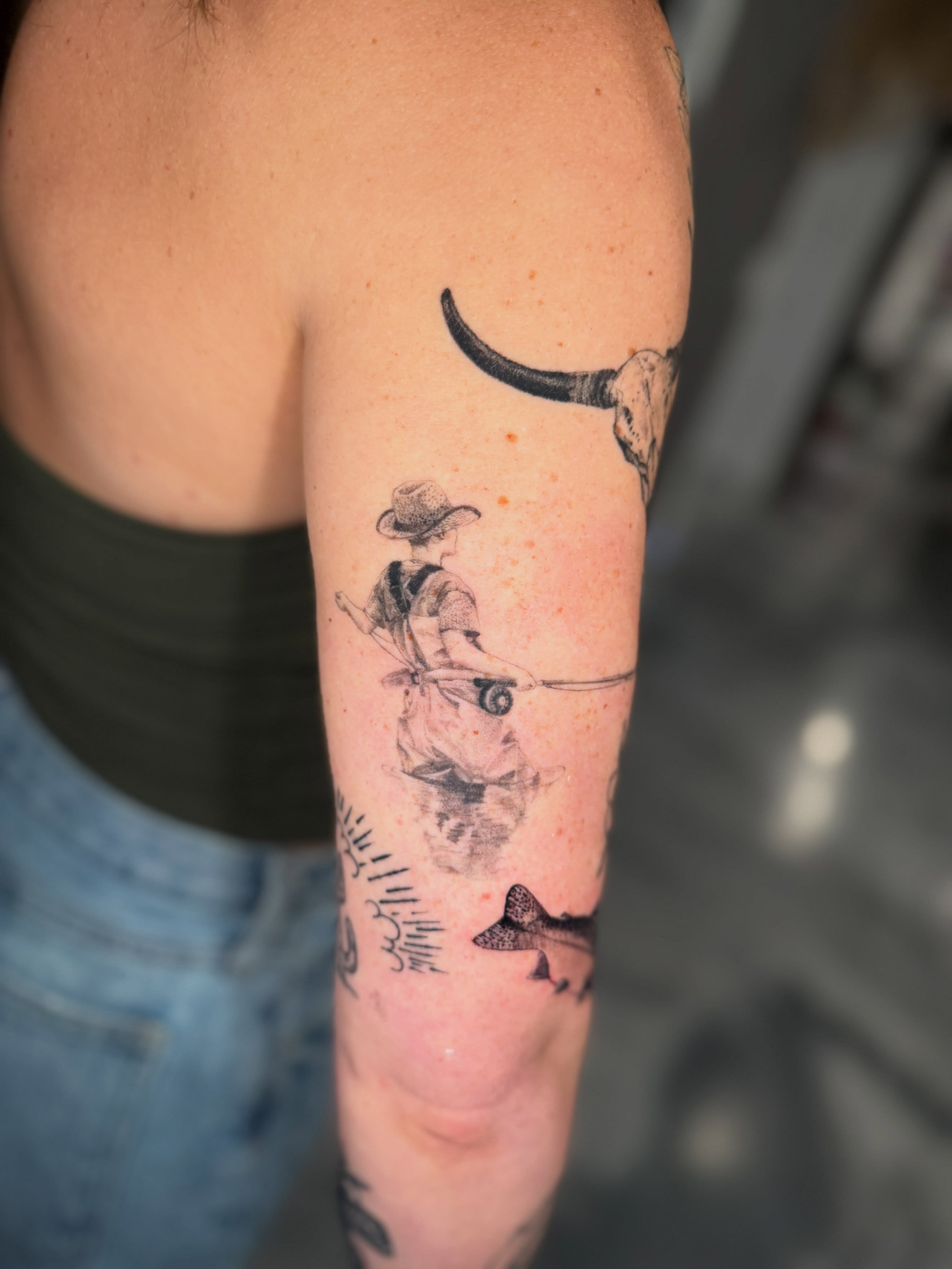 Cowboy riding bull black and grey tattoo on the forearm by Amber Starr, Midvale, Utah