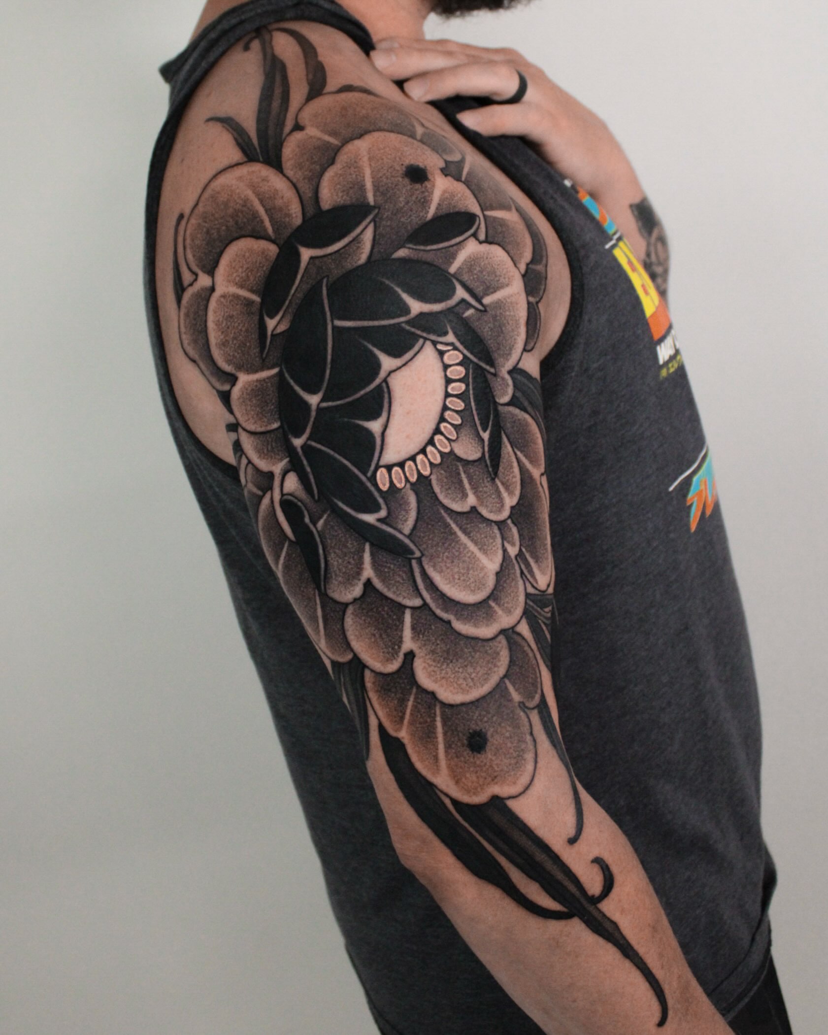 Peony dotwork tattoo on the upper arm by Heather Apgar