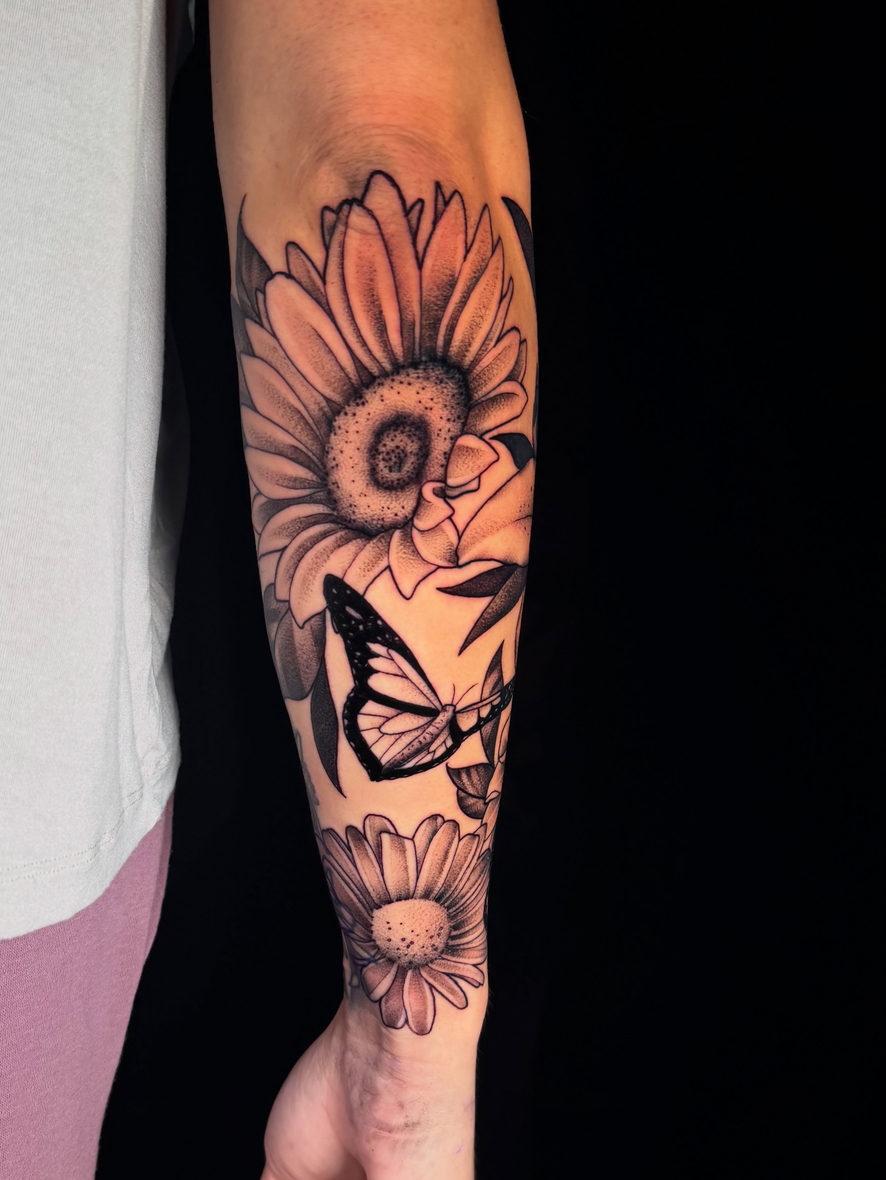 Sunflower and butterfly dotwork tattoo on the forearm by Pam Sanders