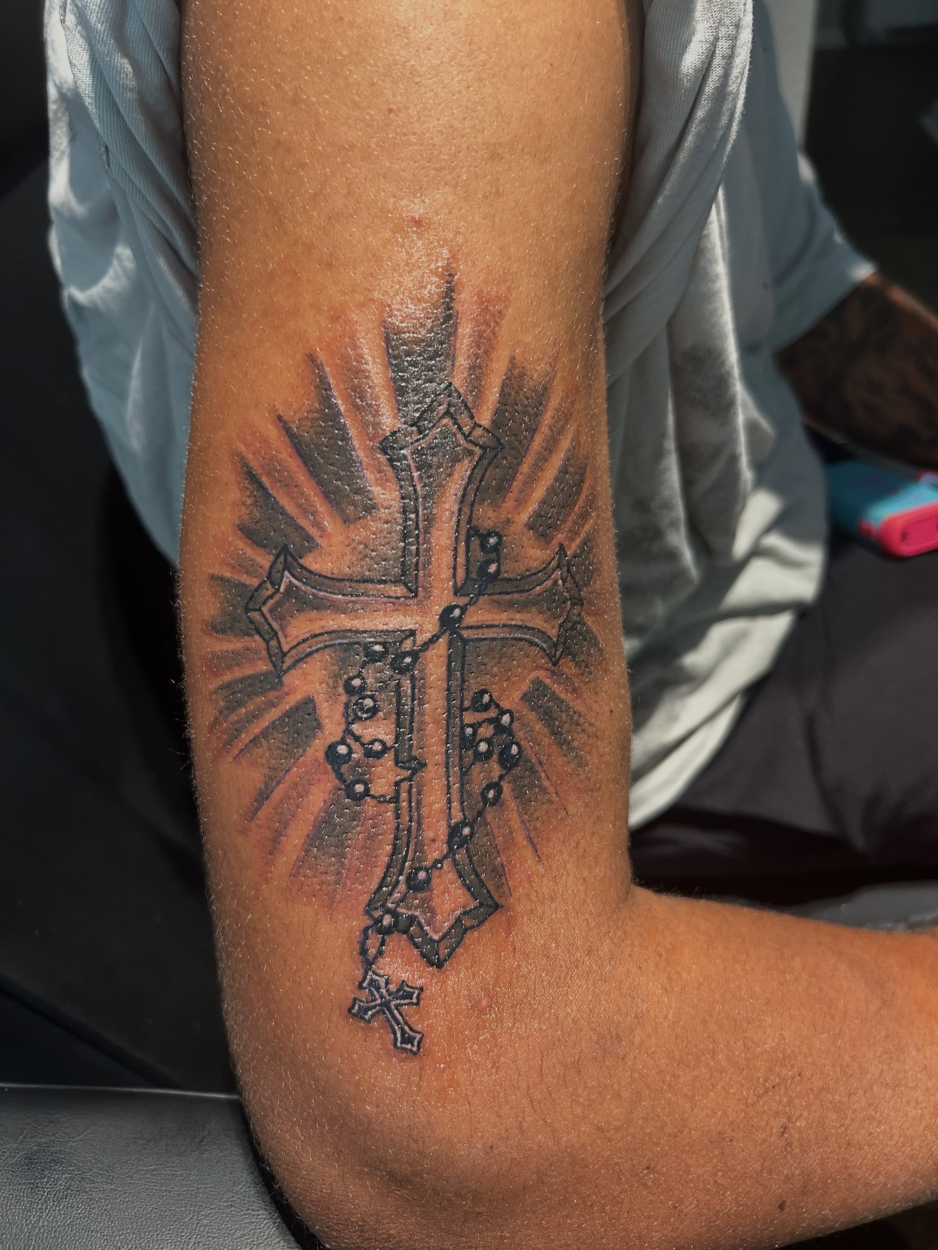 Cross with rosary black and grey tattoo on the forearm by @tatzbythadon