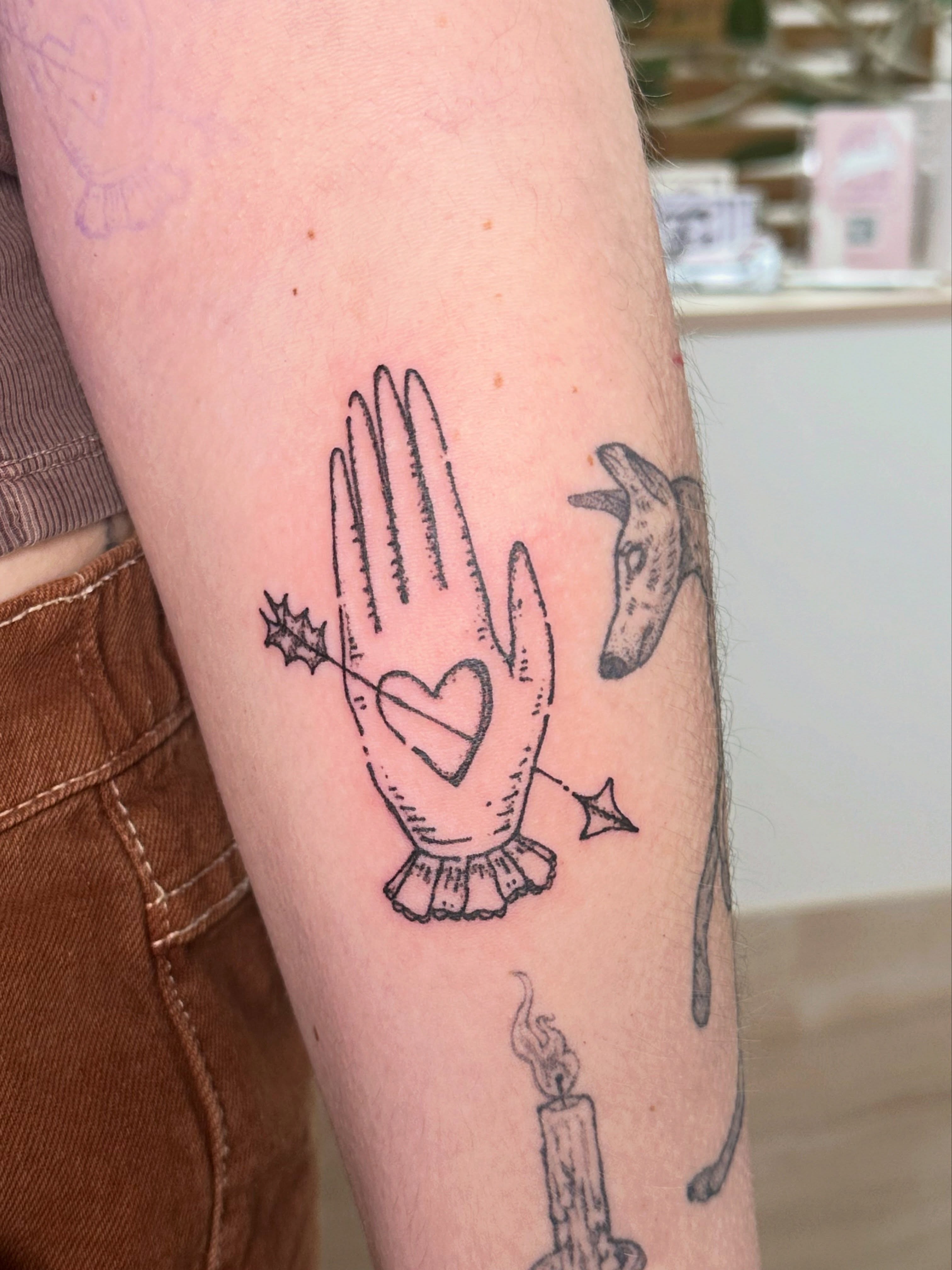 Hand with heart black and grey tattoo on the forearm by Fleur ๐ฅ