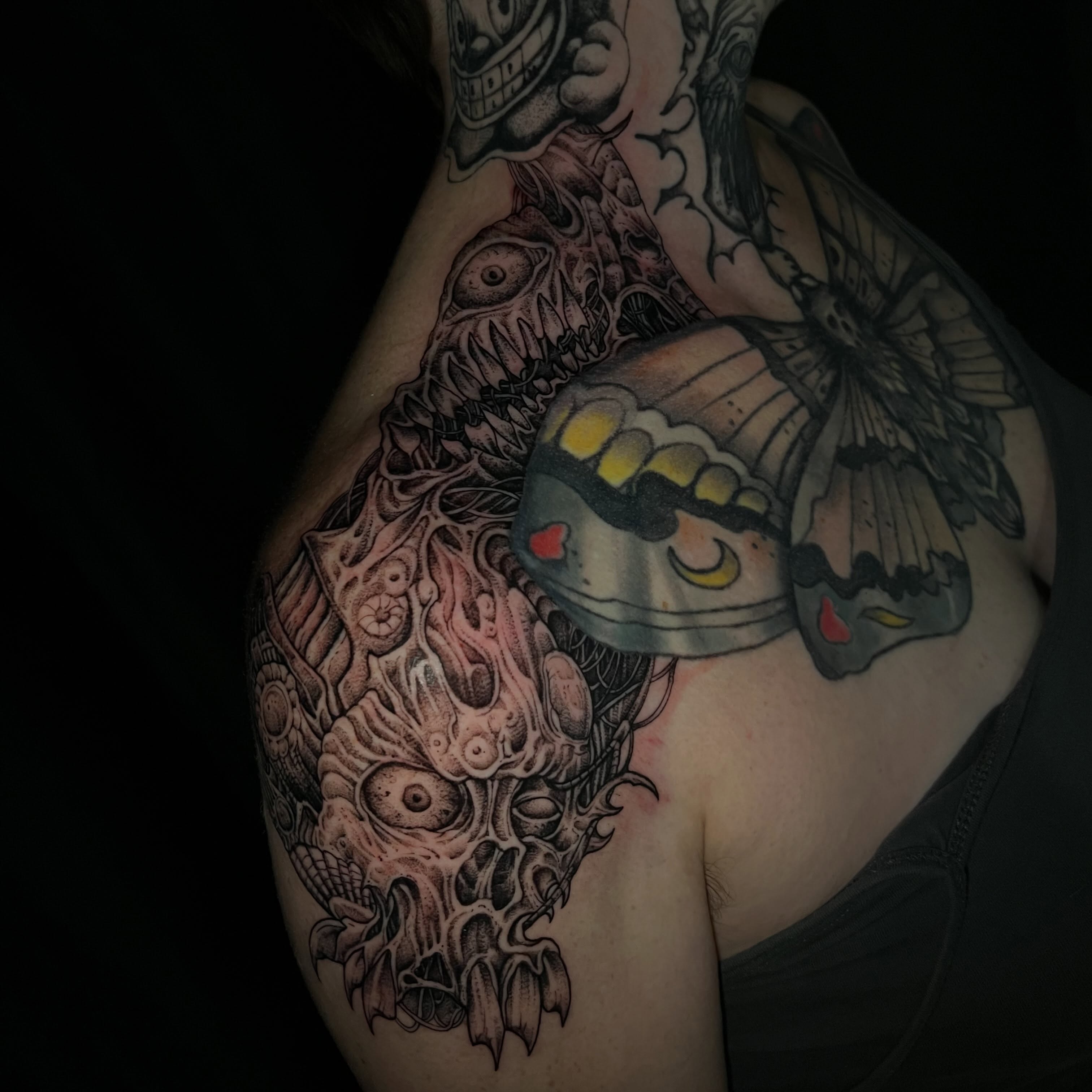 Monster with butterfly dark realism tattoo on the shoulder by Crawlspacecadet