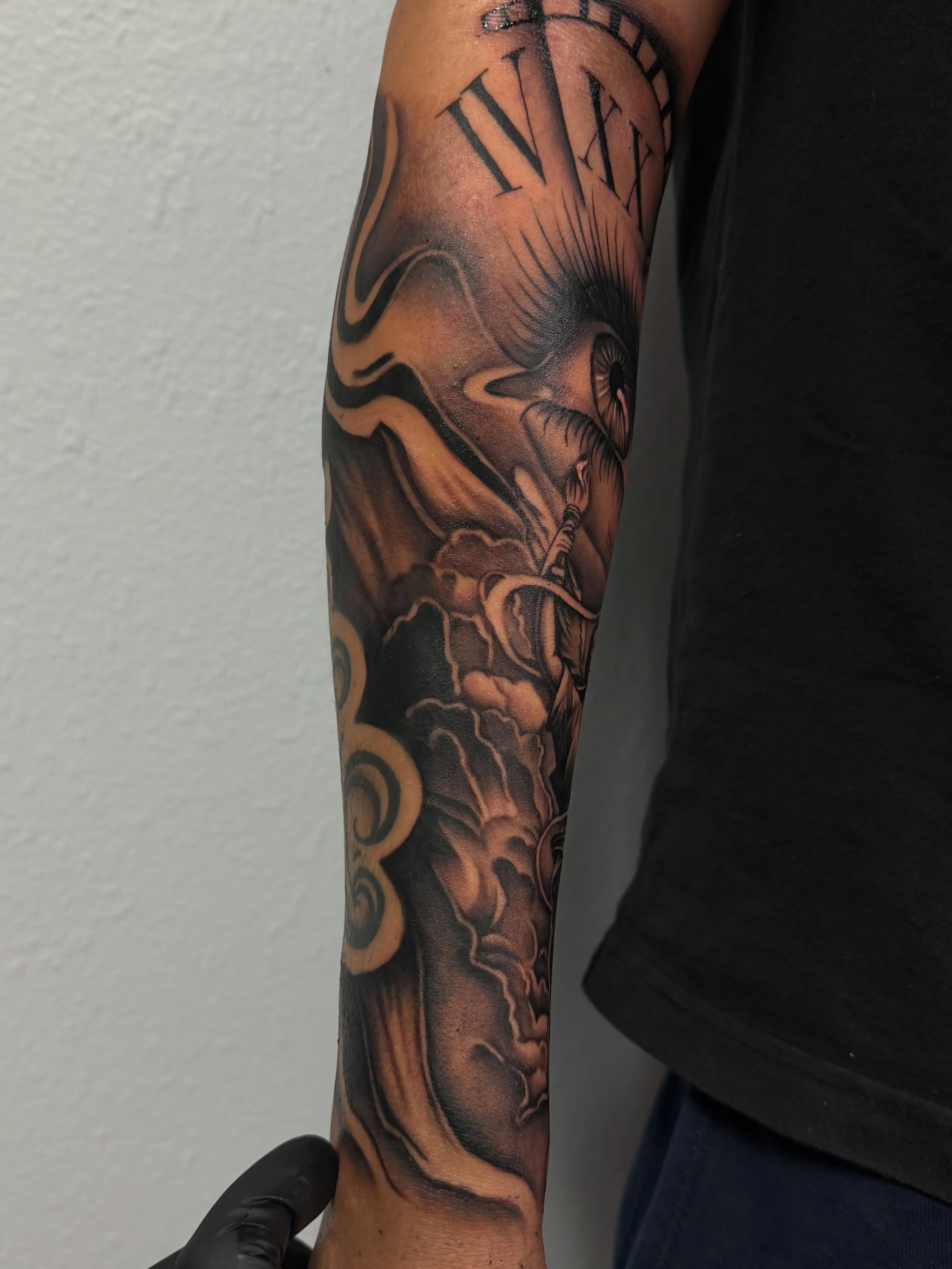 Clock and bird black and grey tattoo on the forearm by San Diego Tattoo Artist