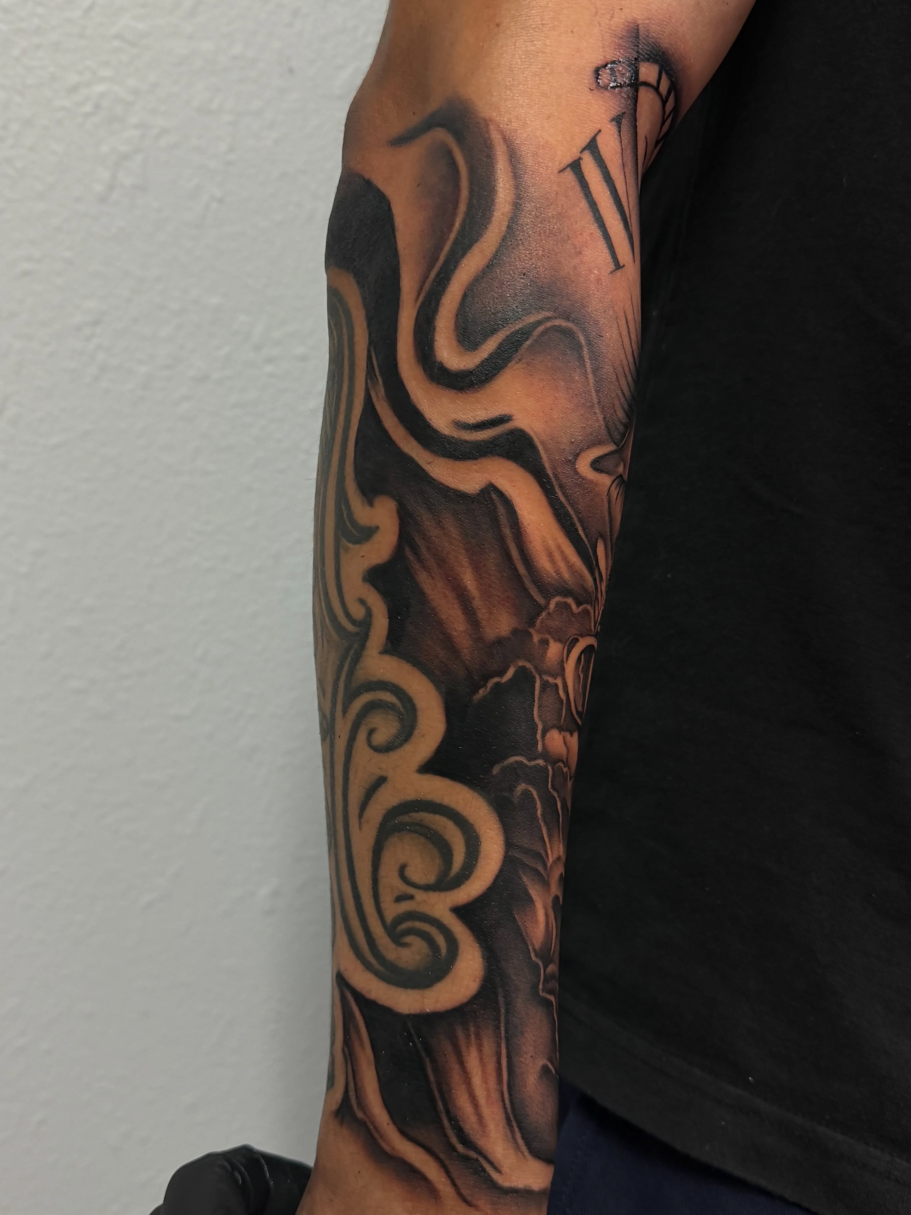 Floral swirls realism tattoo on the forearm by San Diego Tattoo Artist
