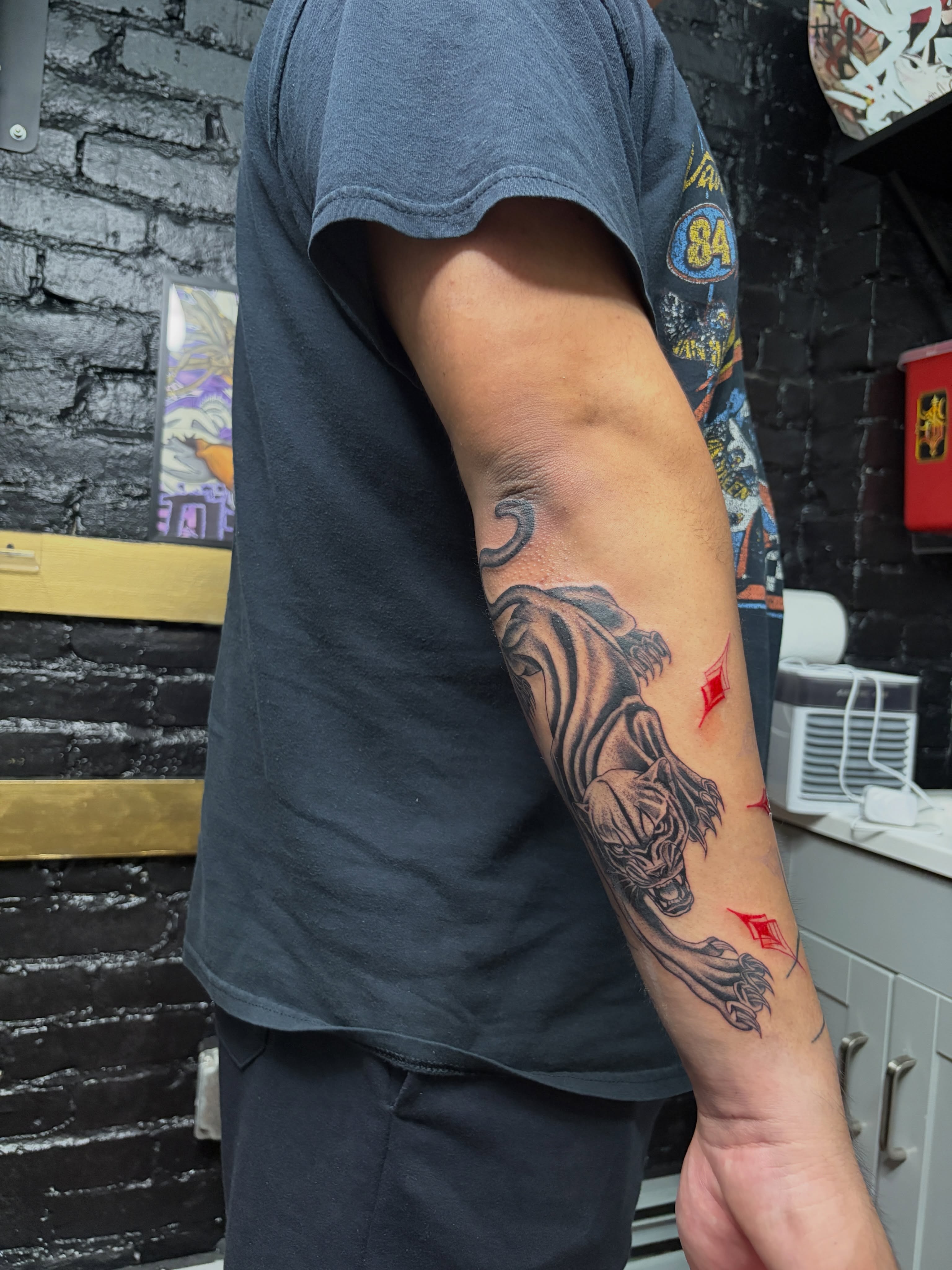 Lion and diamond black and grey tattoo on the forearm by Destineé