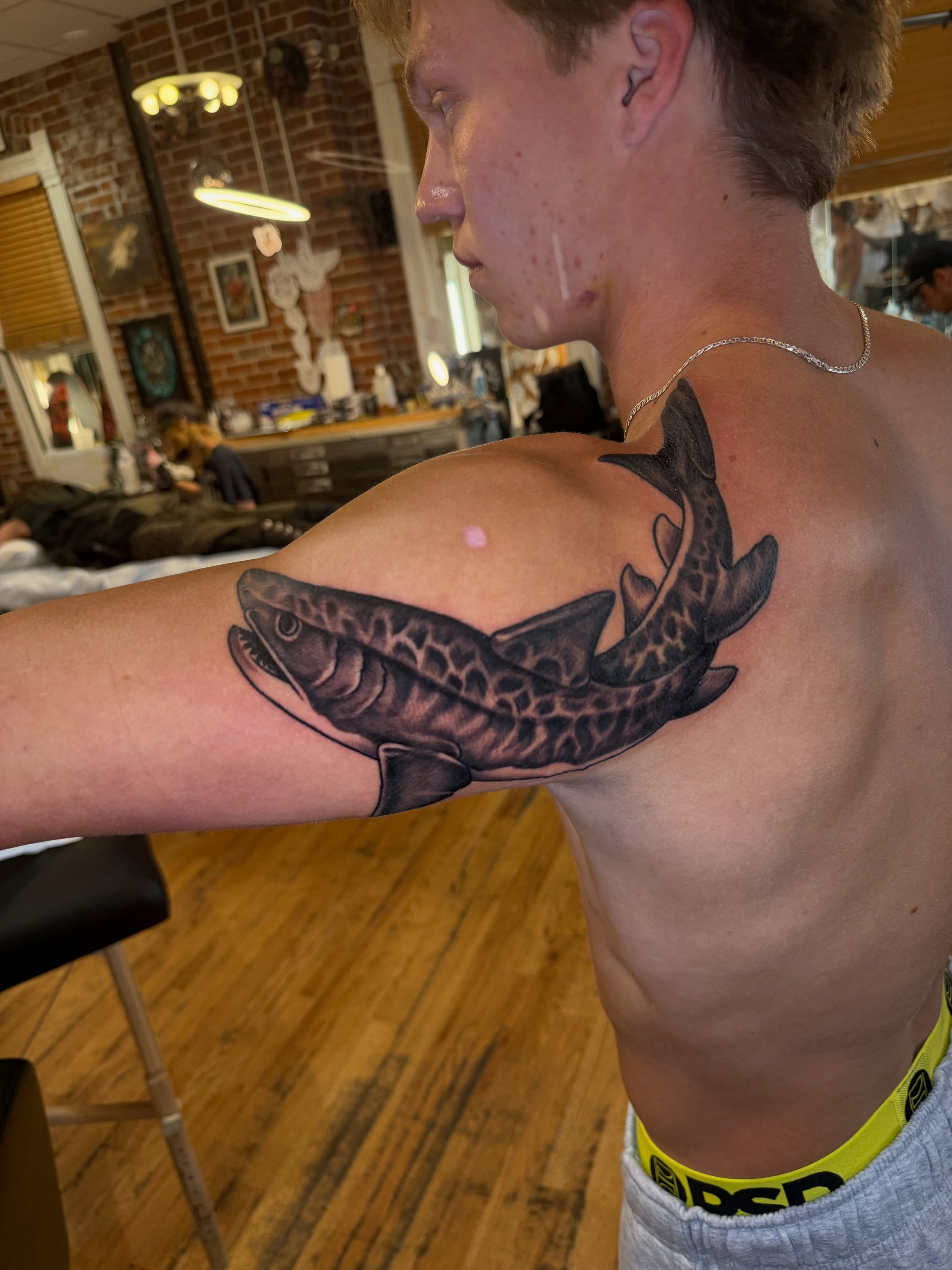 Shark realism tattoo on the upper arm by Kevin R. Onley