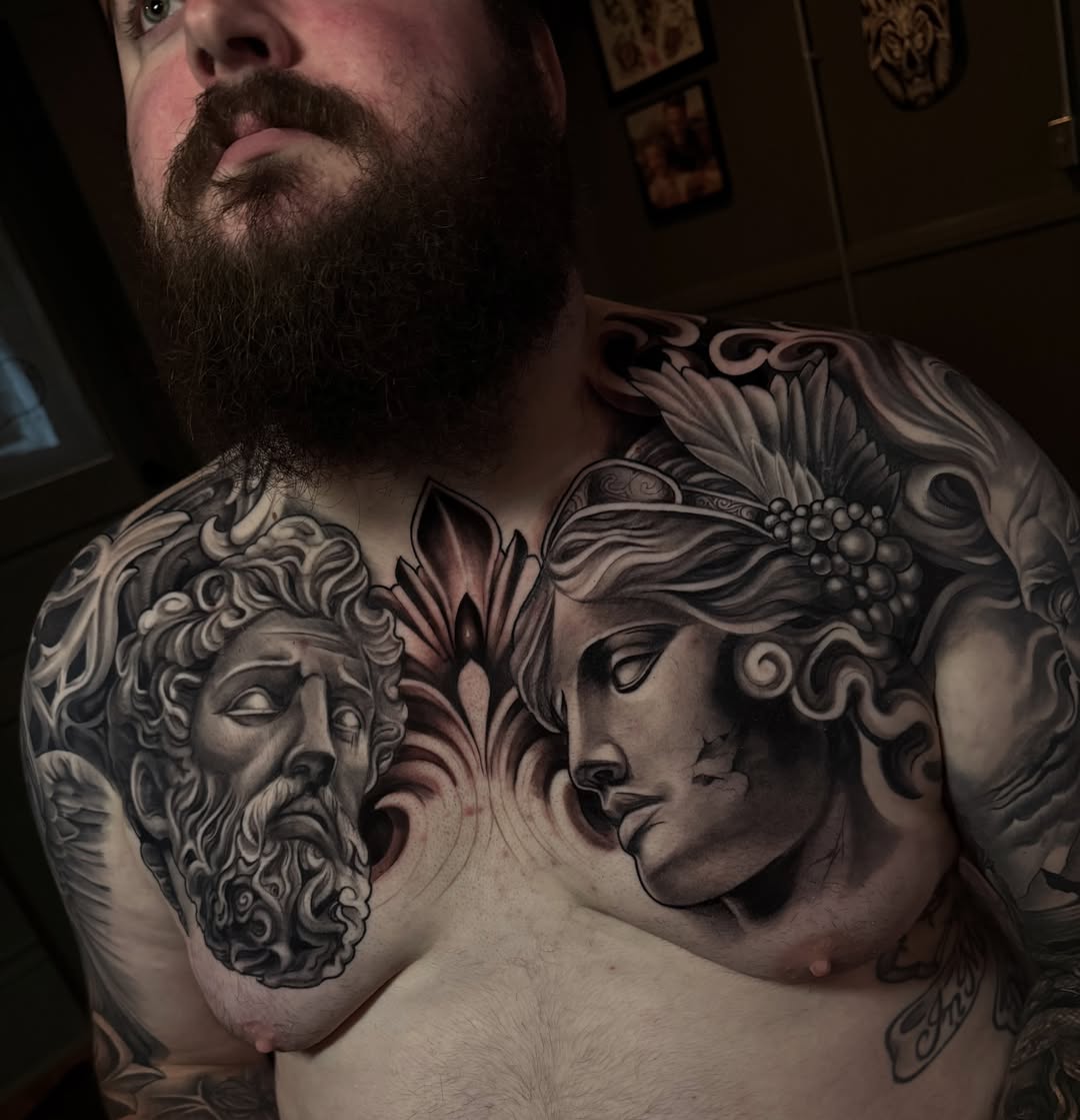 Mythical heads realism tattoo on the chest by Corey Ryan
