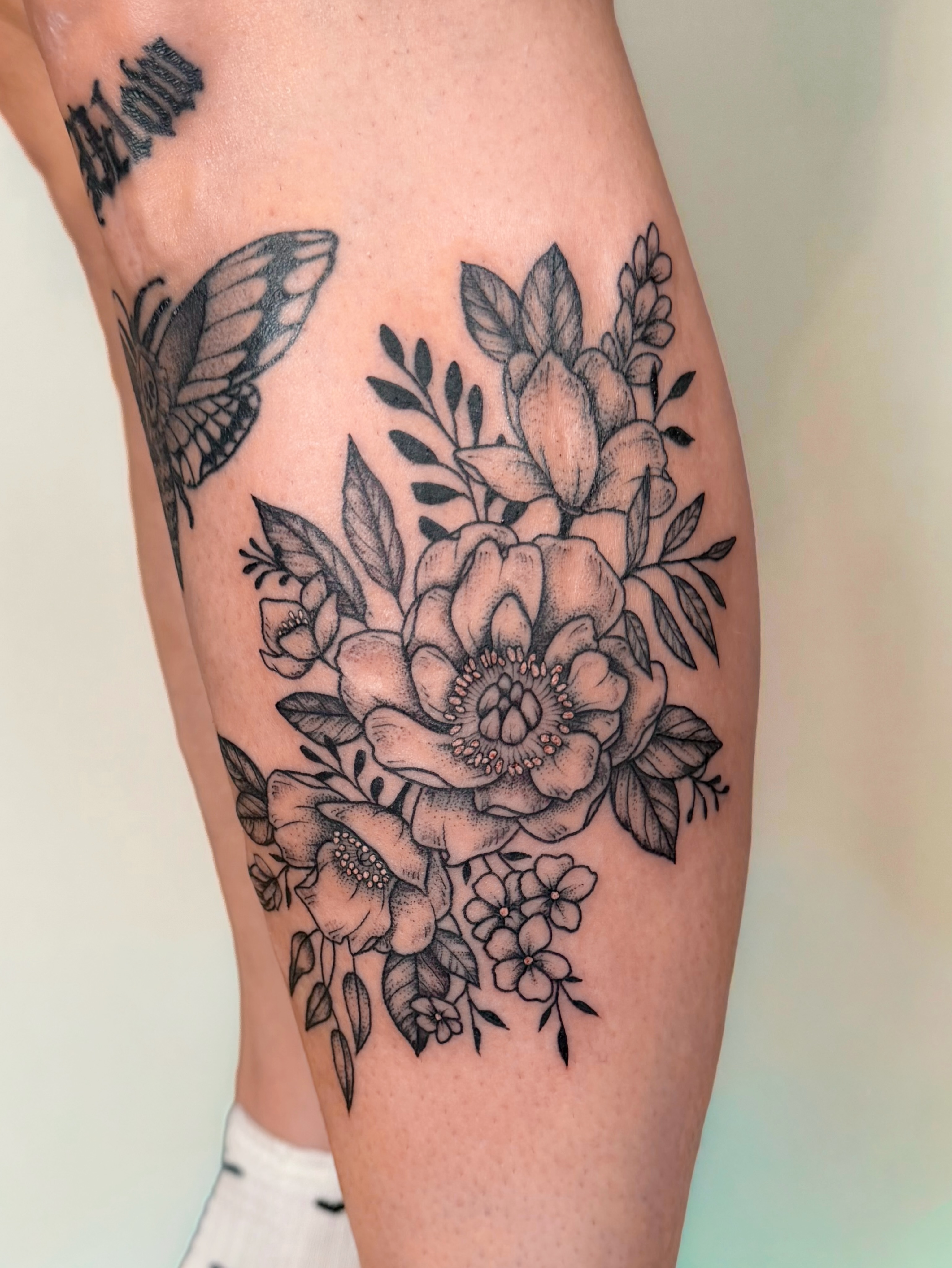 Floral bouquet black and grey tattoo on the calf by Hannah, Portland, Oregon