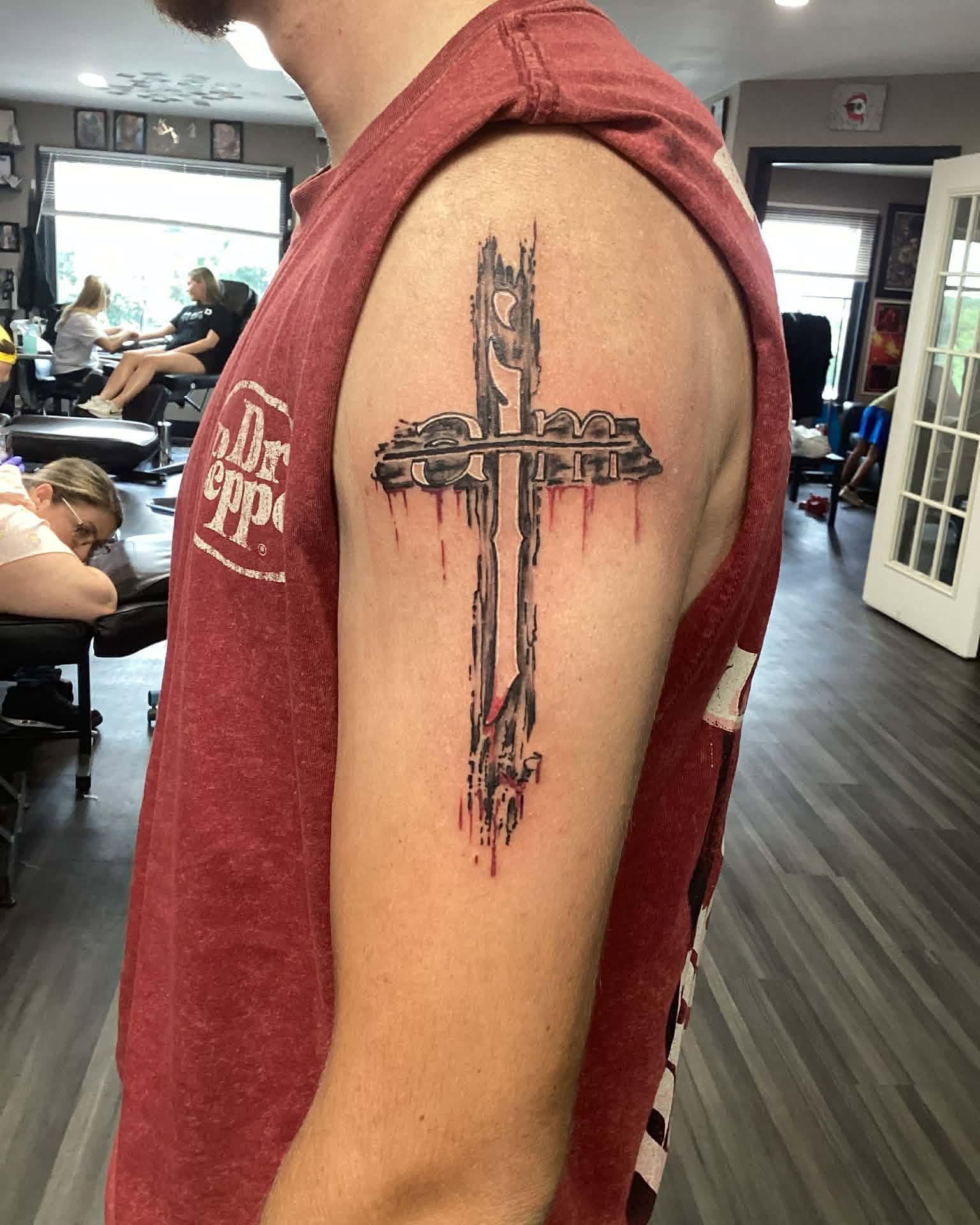 Cross dark realism tattoo on the shoulder by Mike Berry