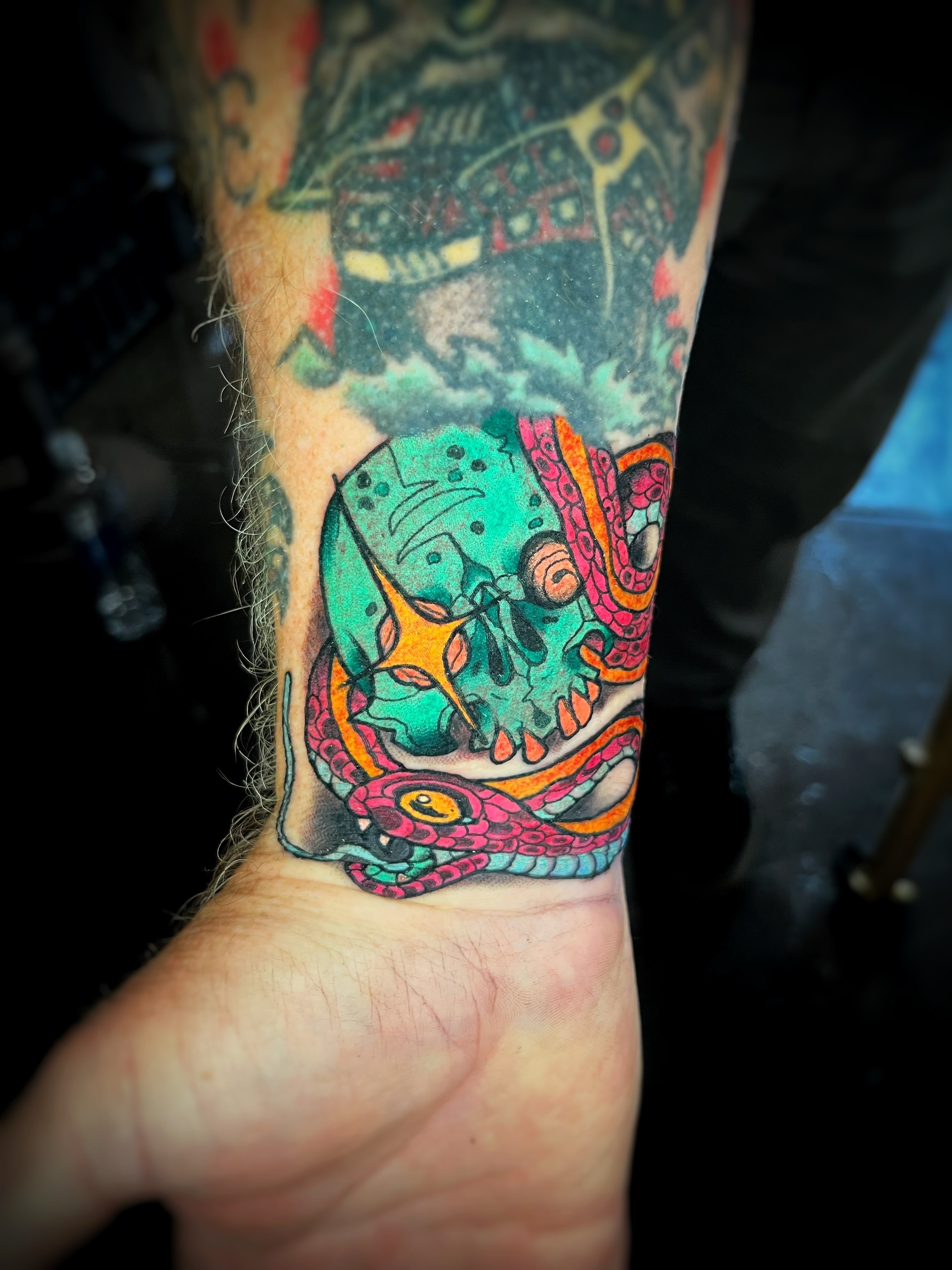 Skull and snake new school tattoo on the forearm by Gilbert Gonzalez