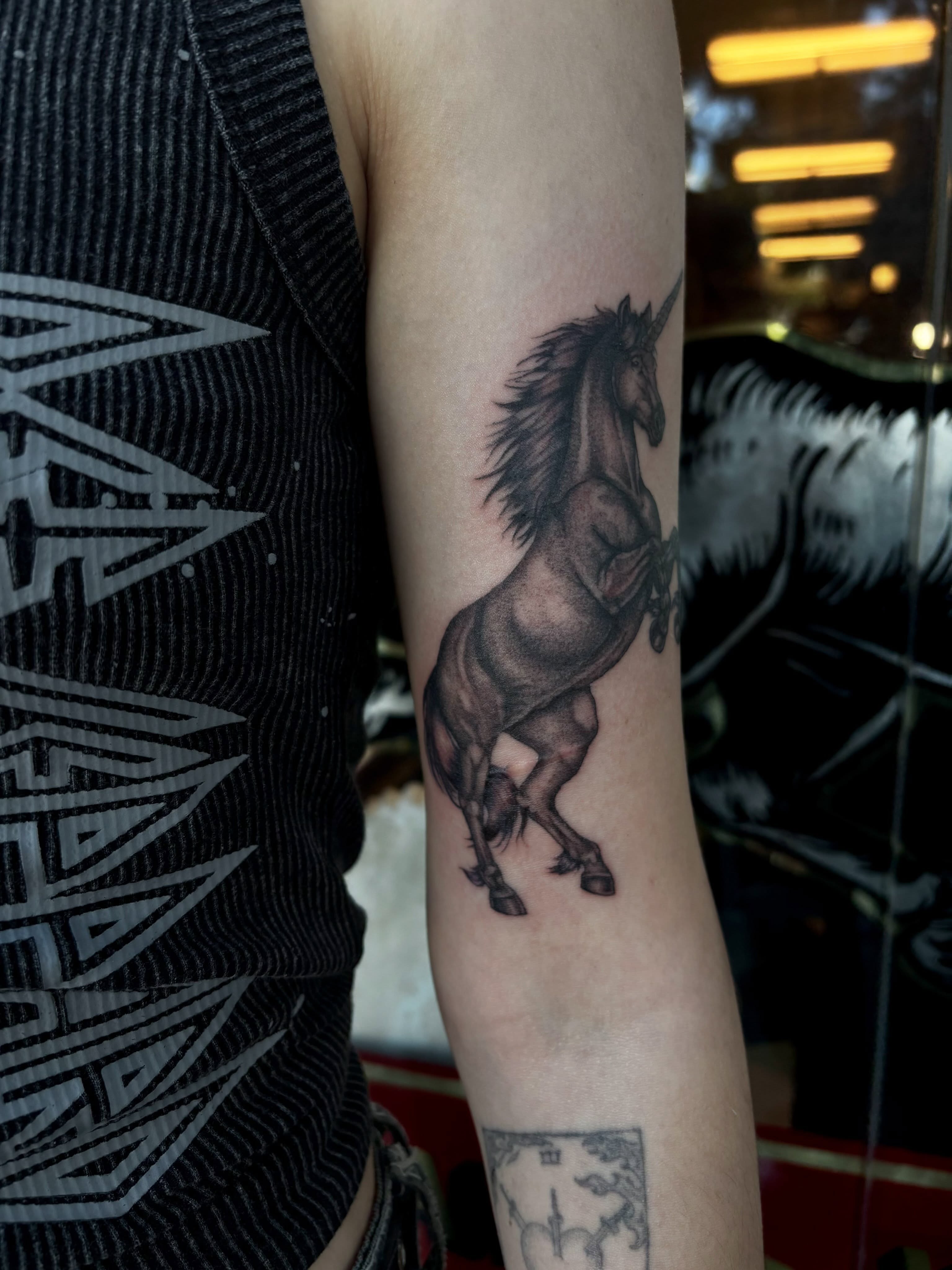 Unicorn black and grey tattoo on the forearm by Alyssa L'Heureux🕴🏼, Los Angeles, California