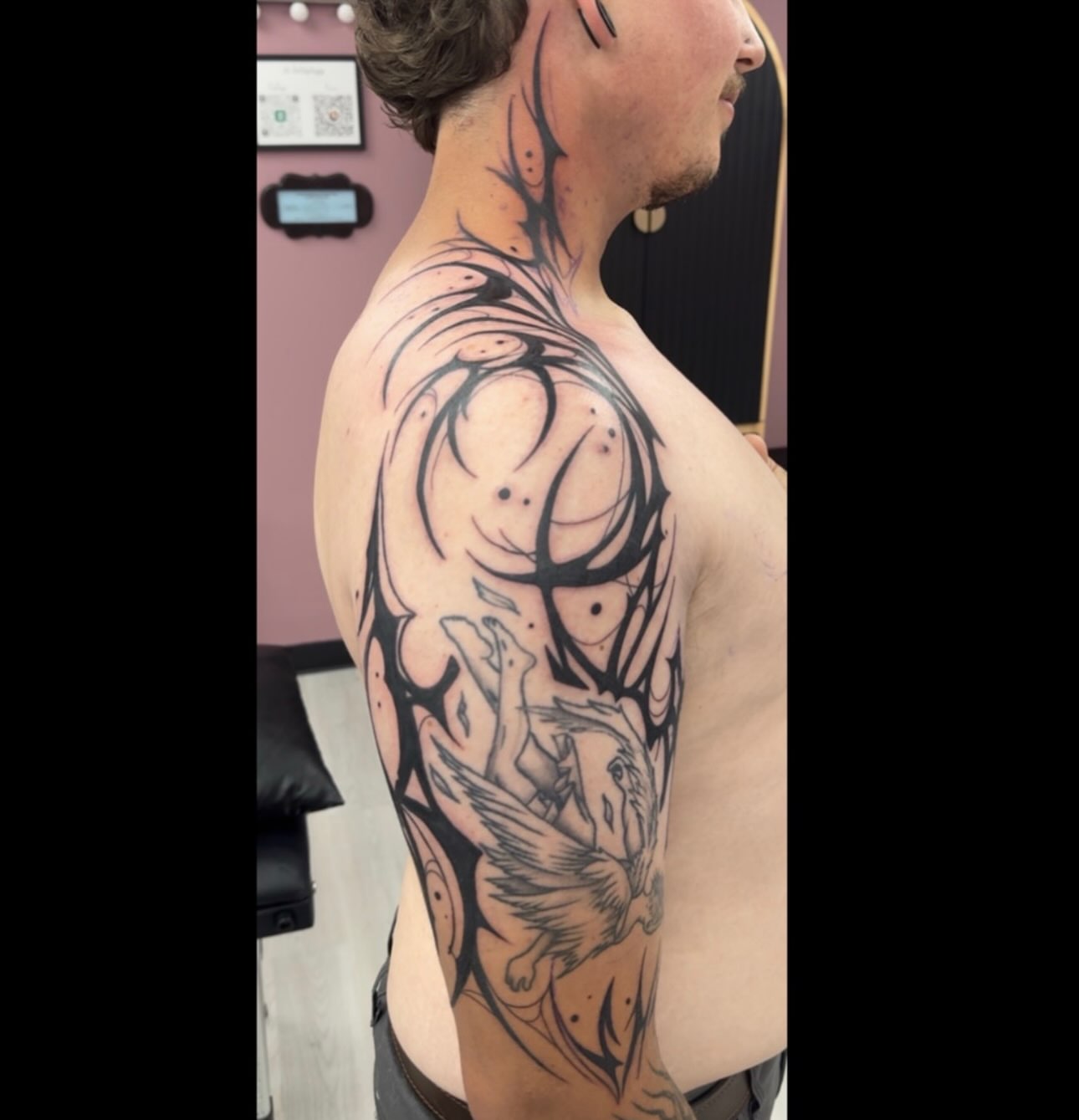 Mythical creature tribal tattoo on the back by Lindsay