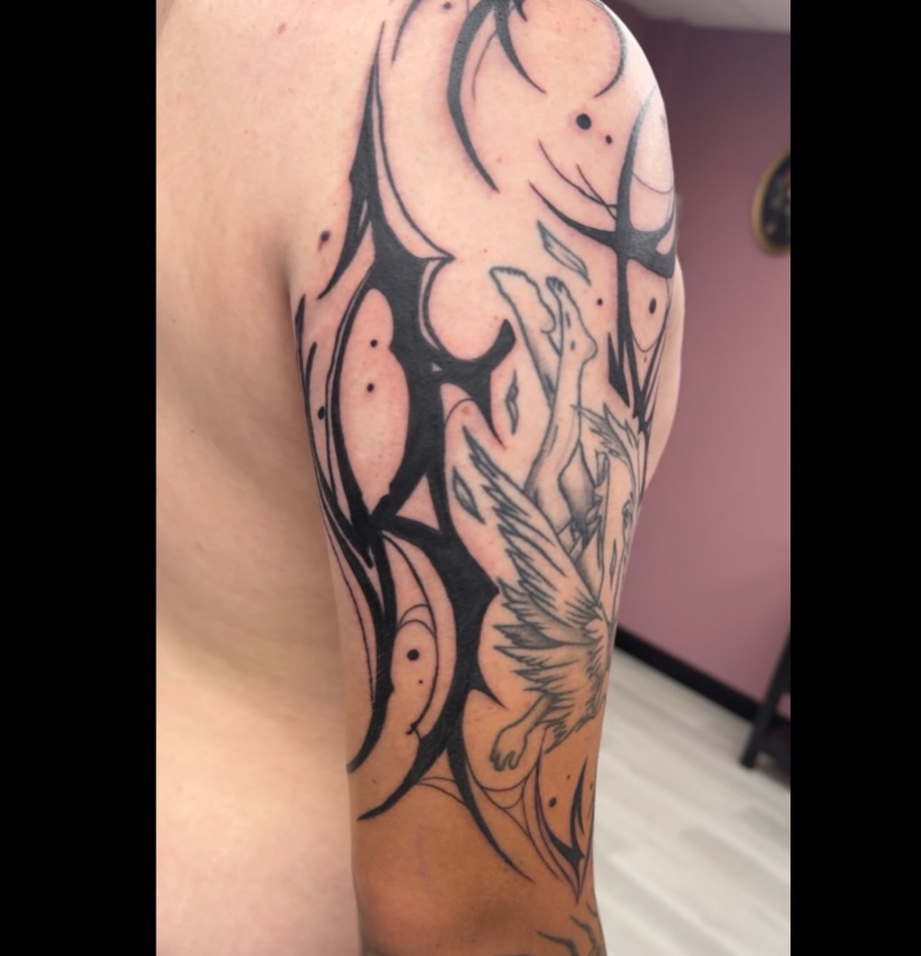 Phoenix tribal tattoo on the upper arm by Lindsay