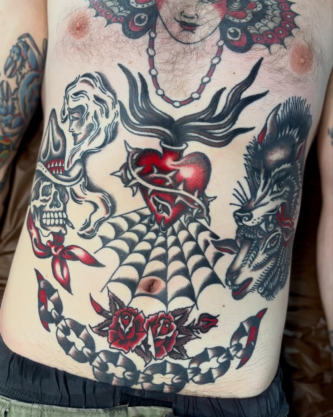 Abstract surrealism American traditional tattoo on the torso by Tia Cave