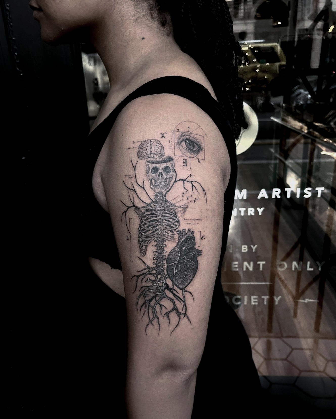 Anatomical skeleton realism tattoo on the upper arm by X°