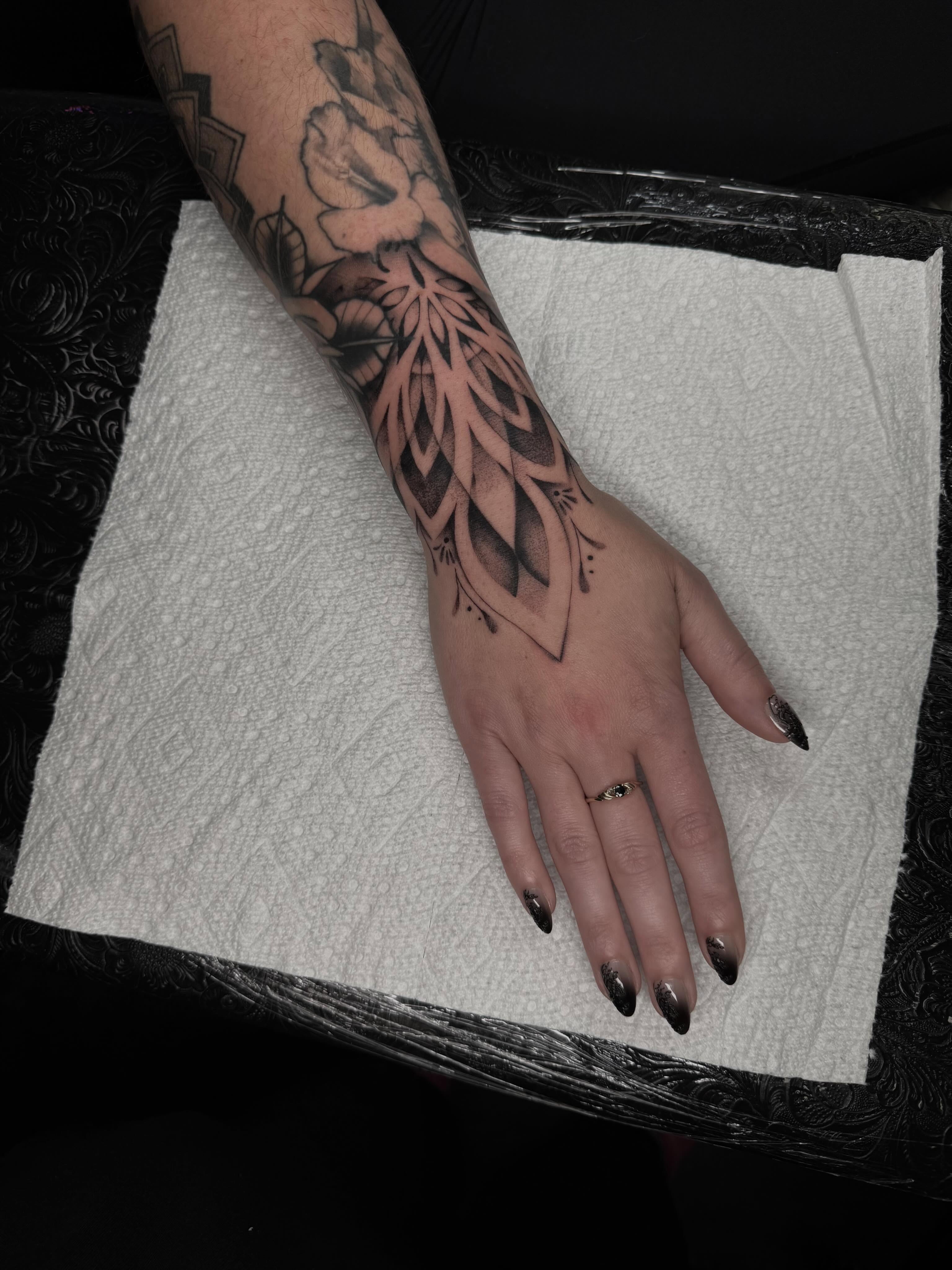 Floral design geometric tattoo on the forearm by Emma Mathis, Springfield, Oregon