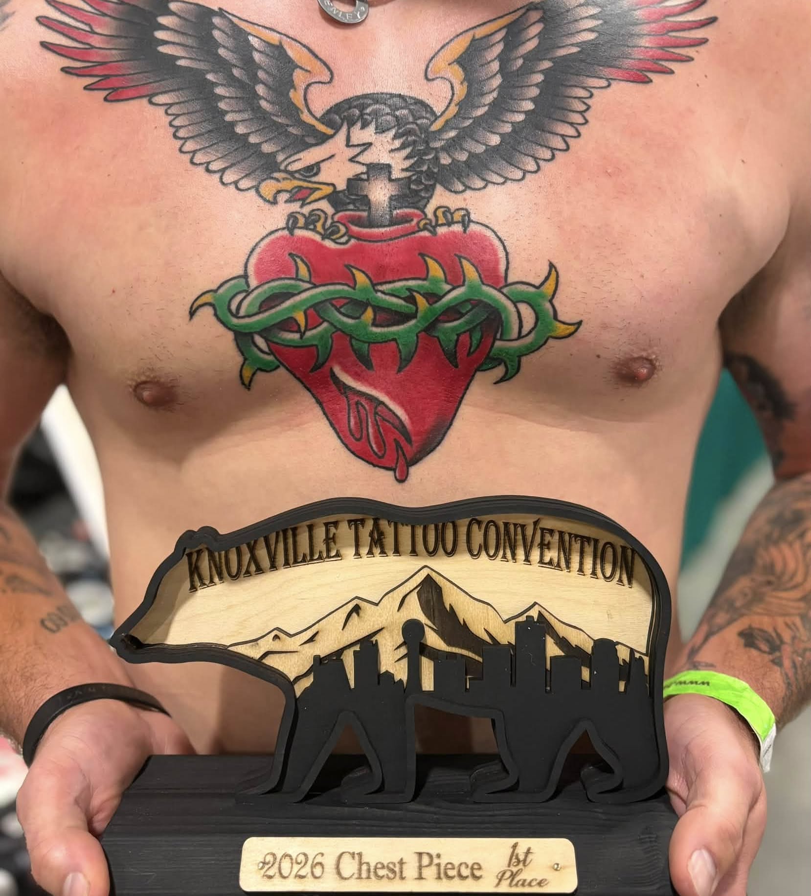 Heart with eagle American traditional tattoo on the chest by Jon Anderson