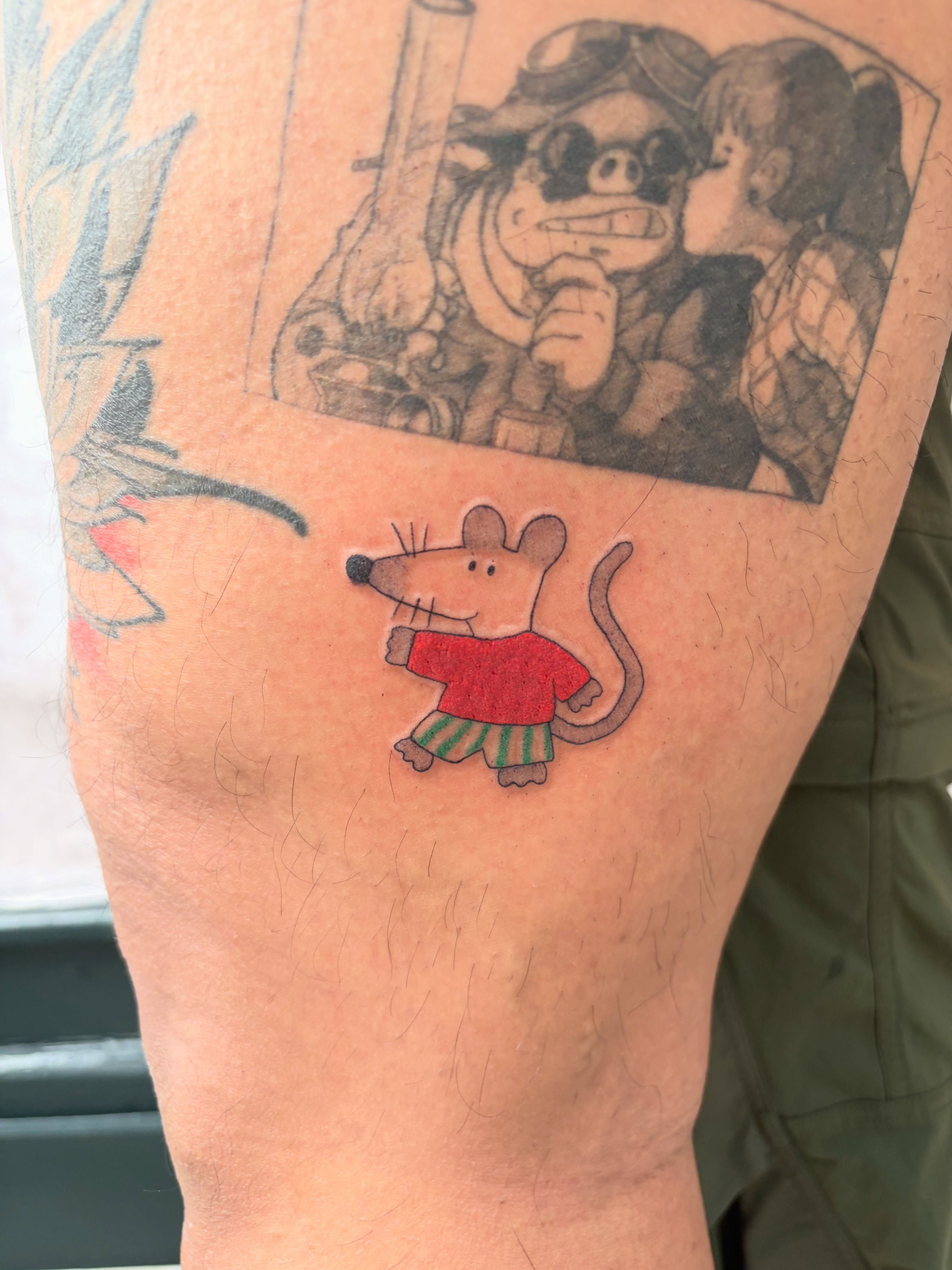 Mouse wearing sweater illustrative tattoo on the forearm by Kyra Monterrosa