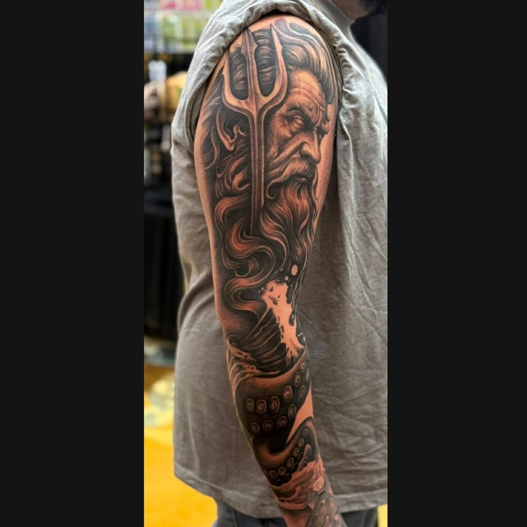God-like figure with trident realism tattoo on the forearm by @nickysix86
