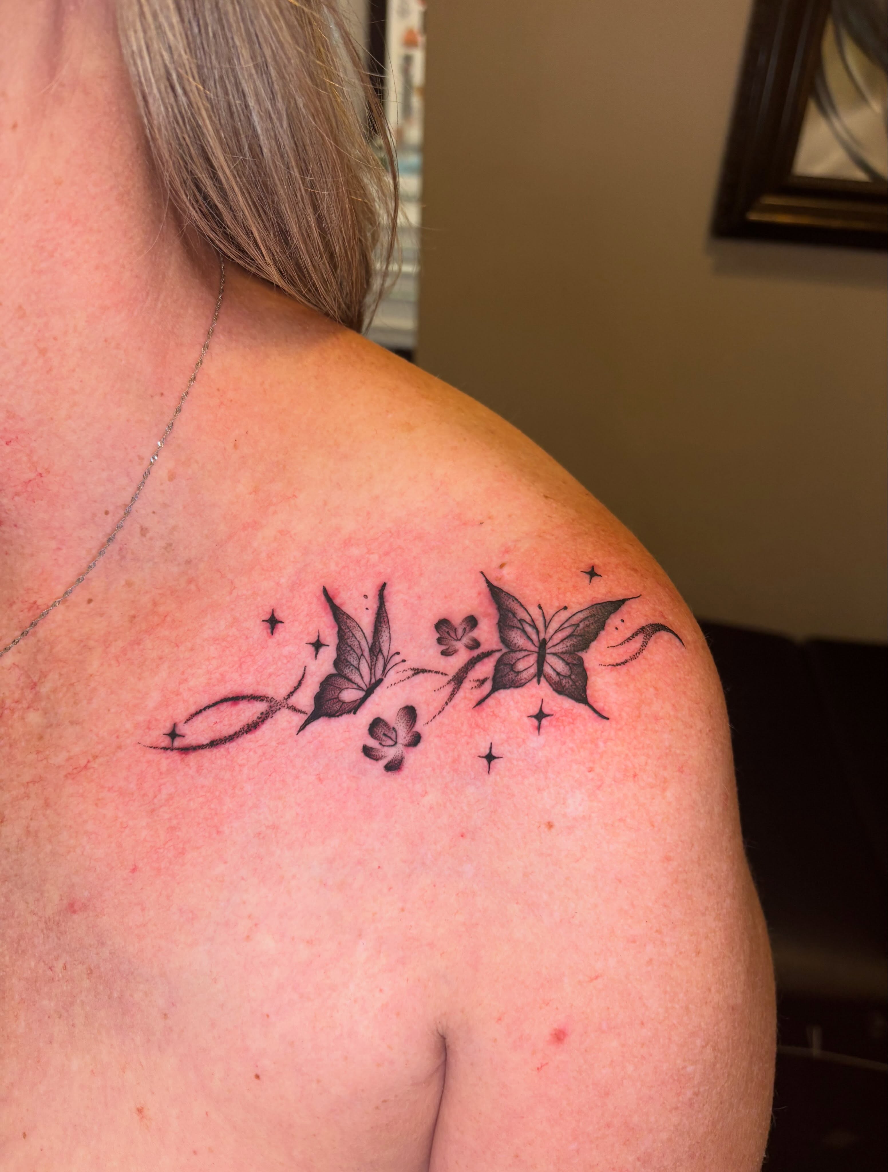 Butterflies and flowers black and grey tattoo on the shoulder by Aubri Aunna