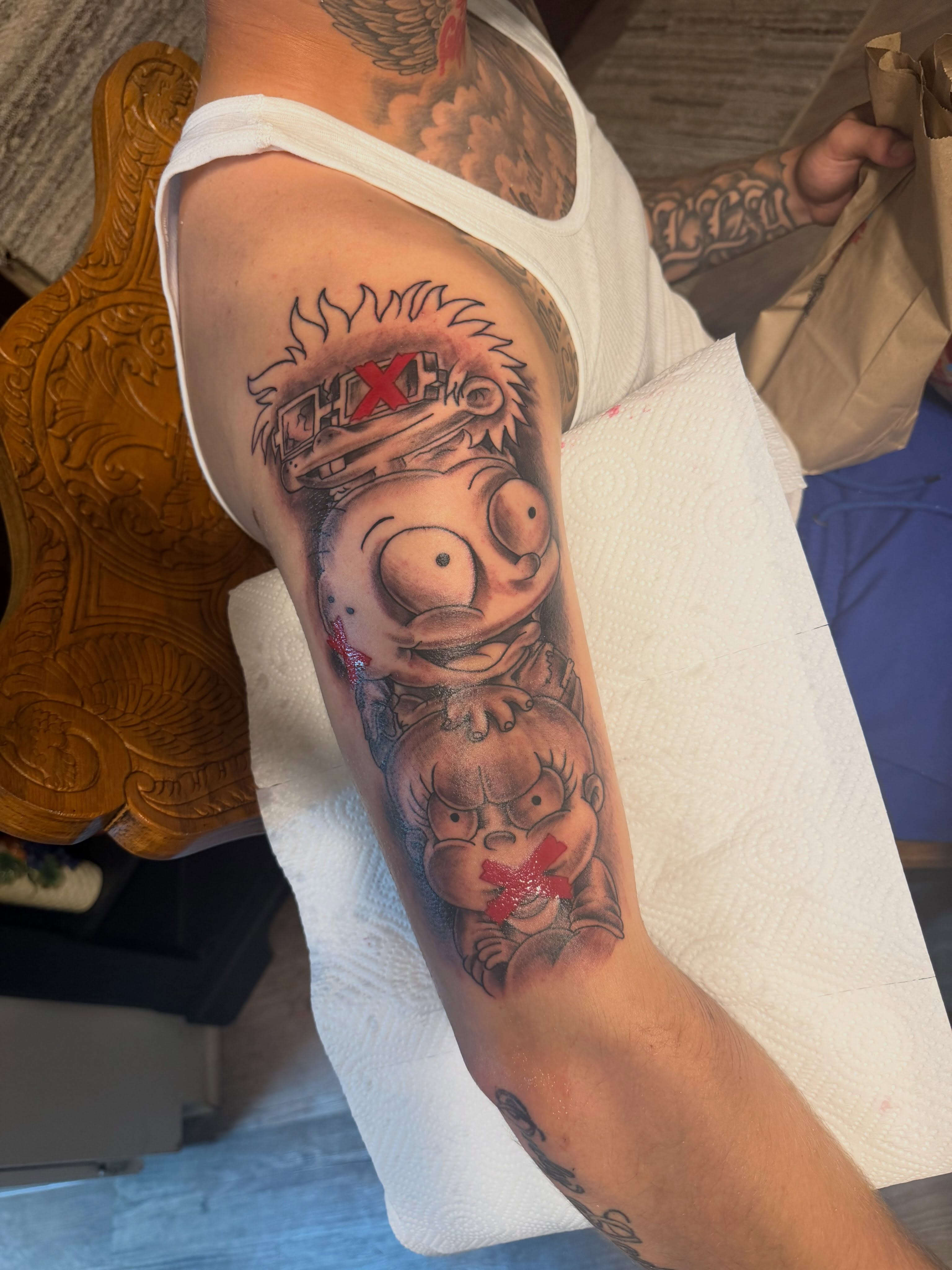 Garfield and Chucky realism tattoo on the forearm by Tattoosbydevon
