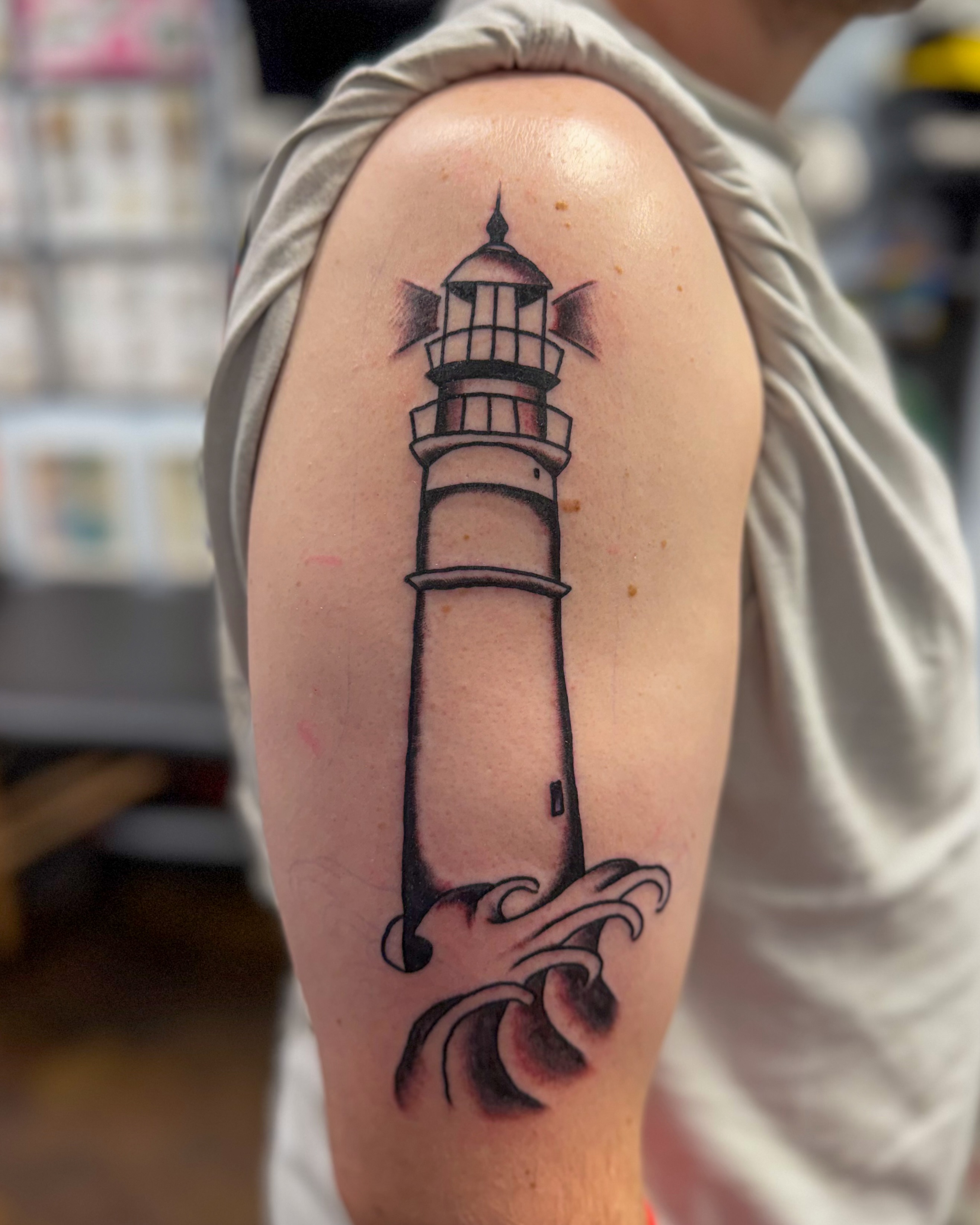 Lighthouse black and grey tattoo on the forearm by Zac Tattooer