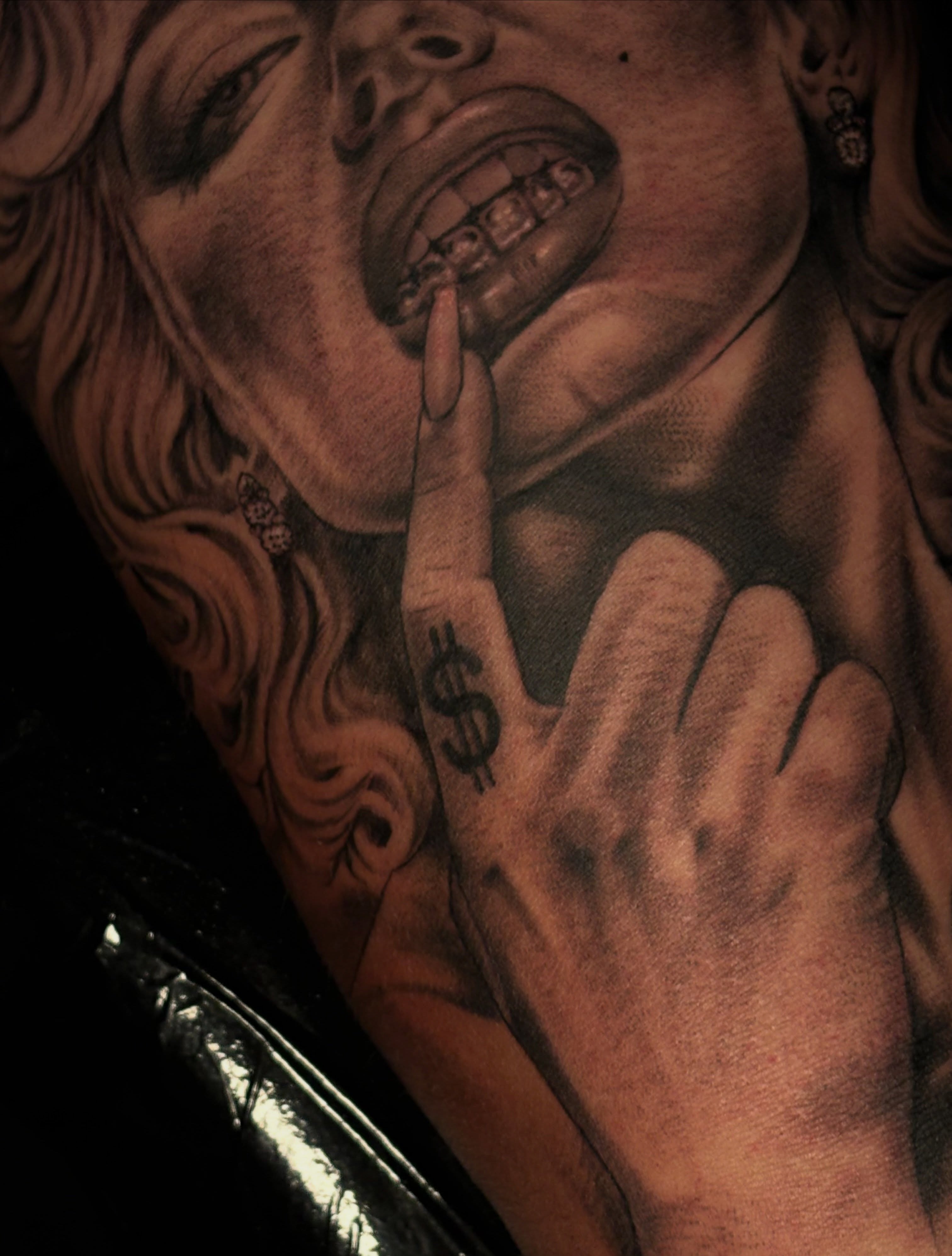 Woman with money sign realism tattoo on the chest by Kevin