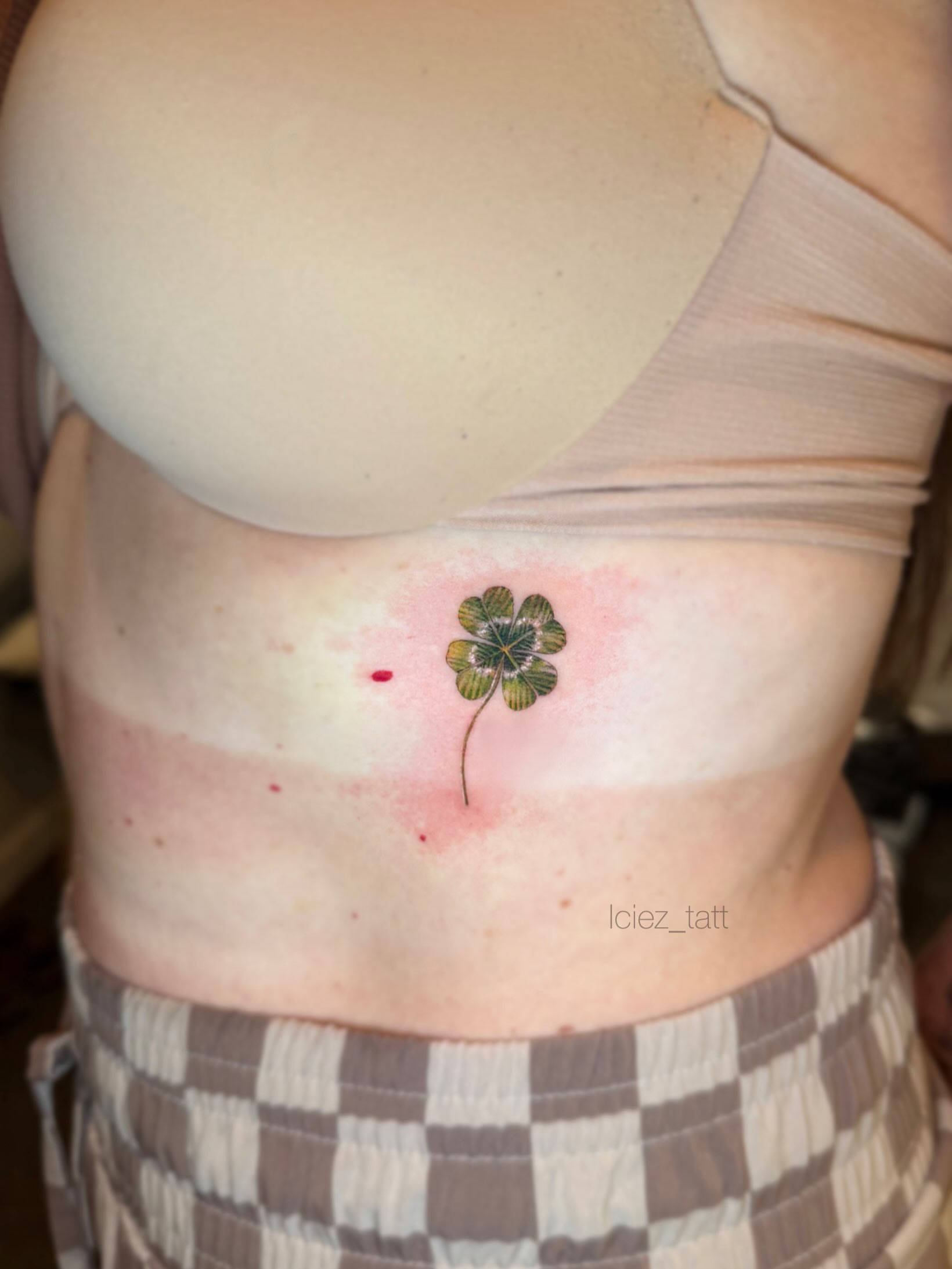 Four-leaf clover dotwork tattoo on the ribs by Iciez