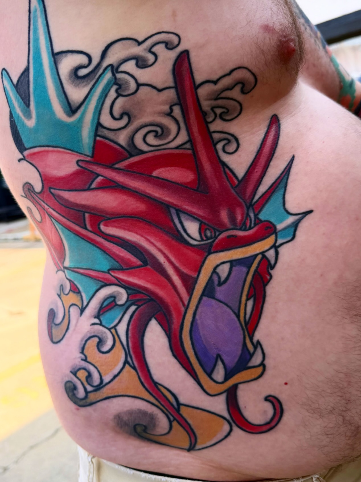 Dragon new school tattoo on the chest by Christopher Layman