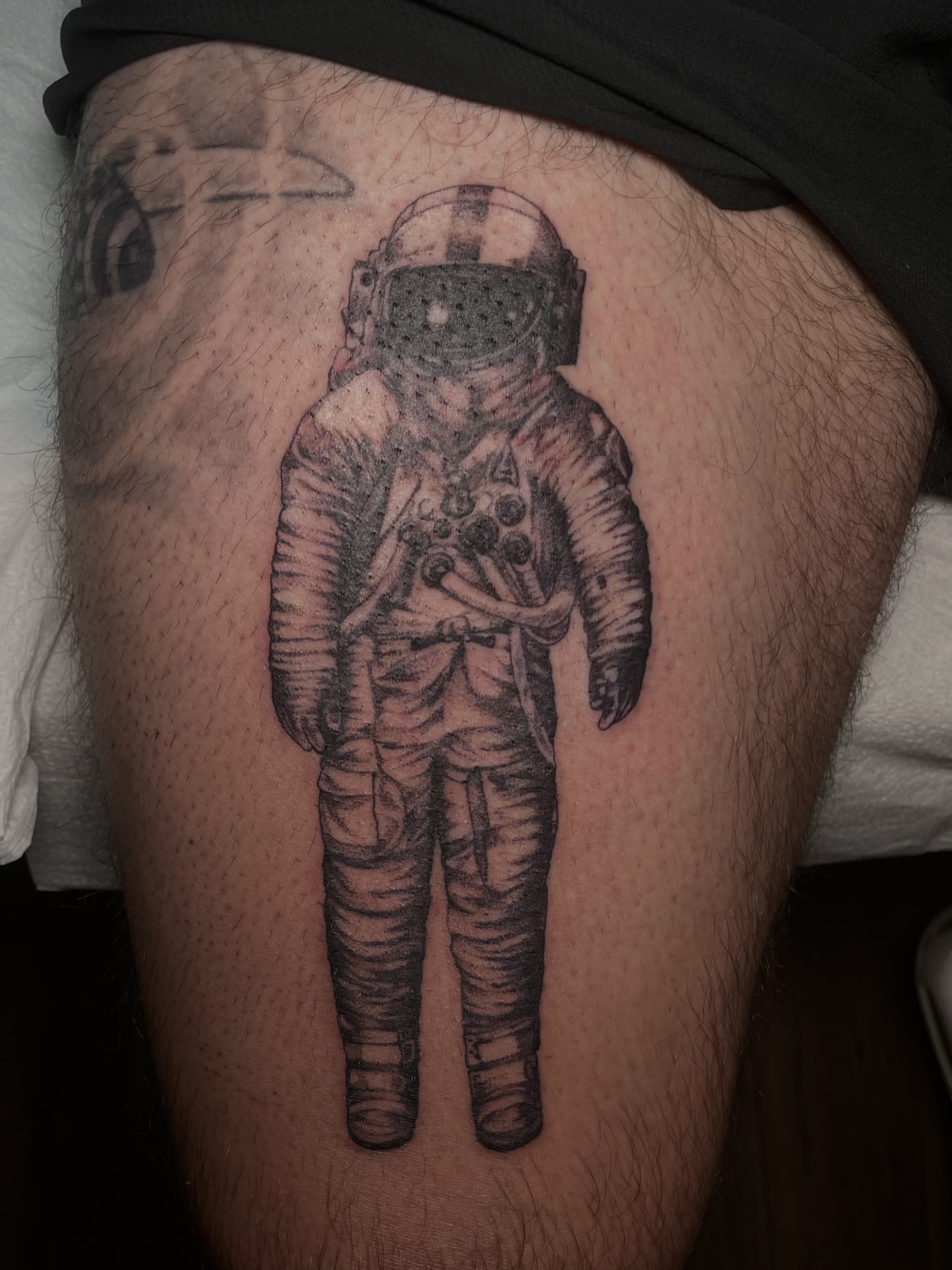 Astronaut black and grey tattoo on the thigh by Eryn, Portland, Oregon