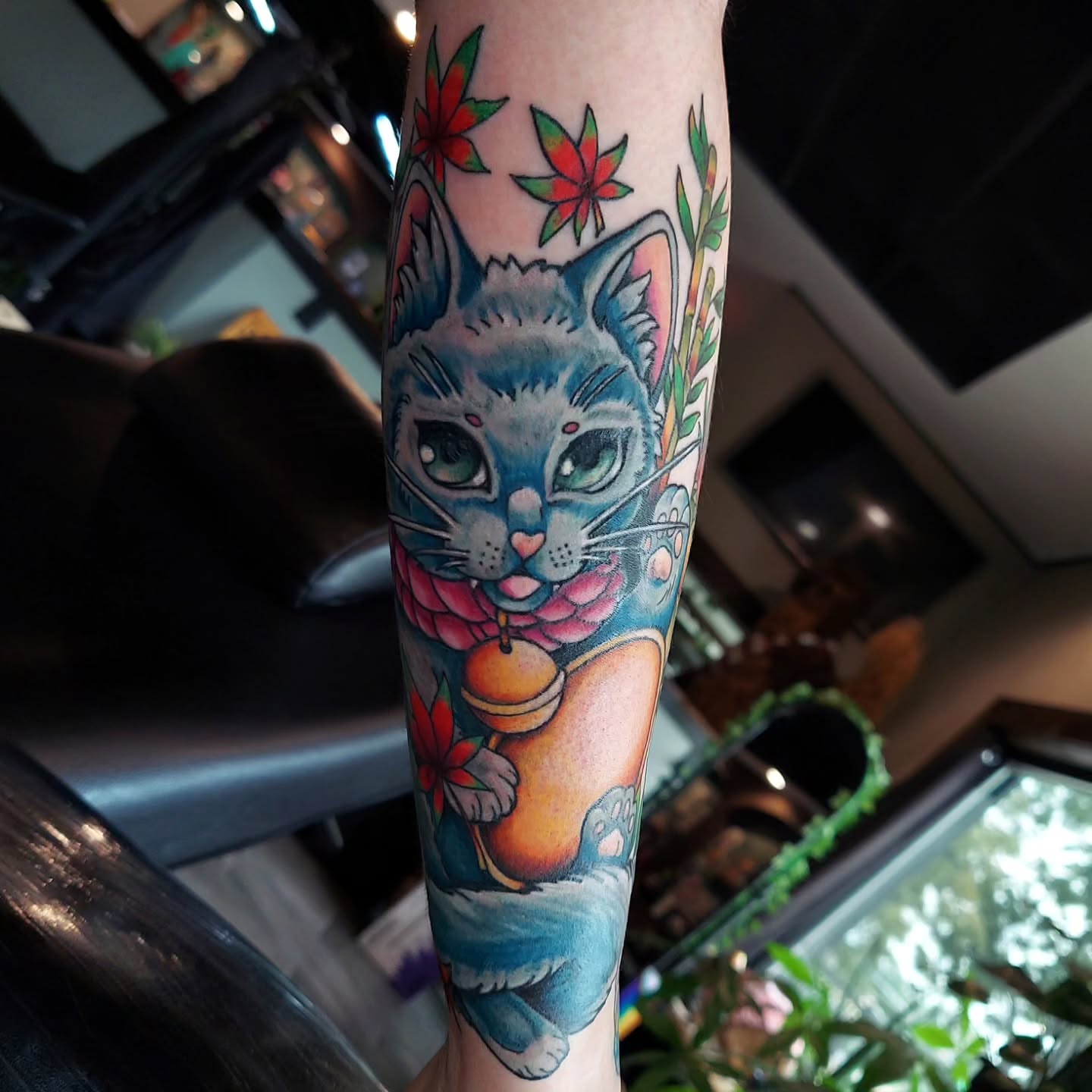 Cat new school tattoo on the forearm by Kari Rhoades, Marion, Iowa