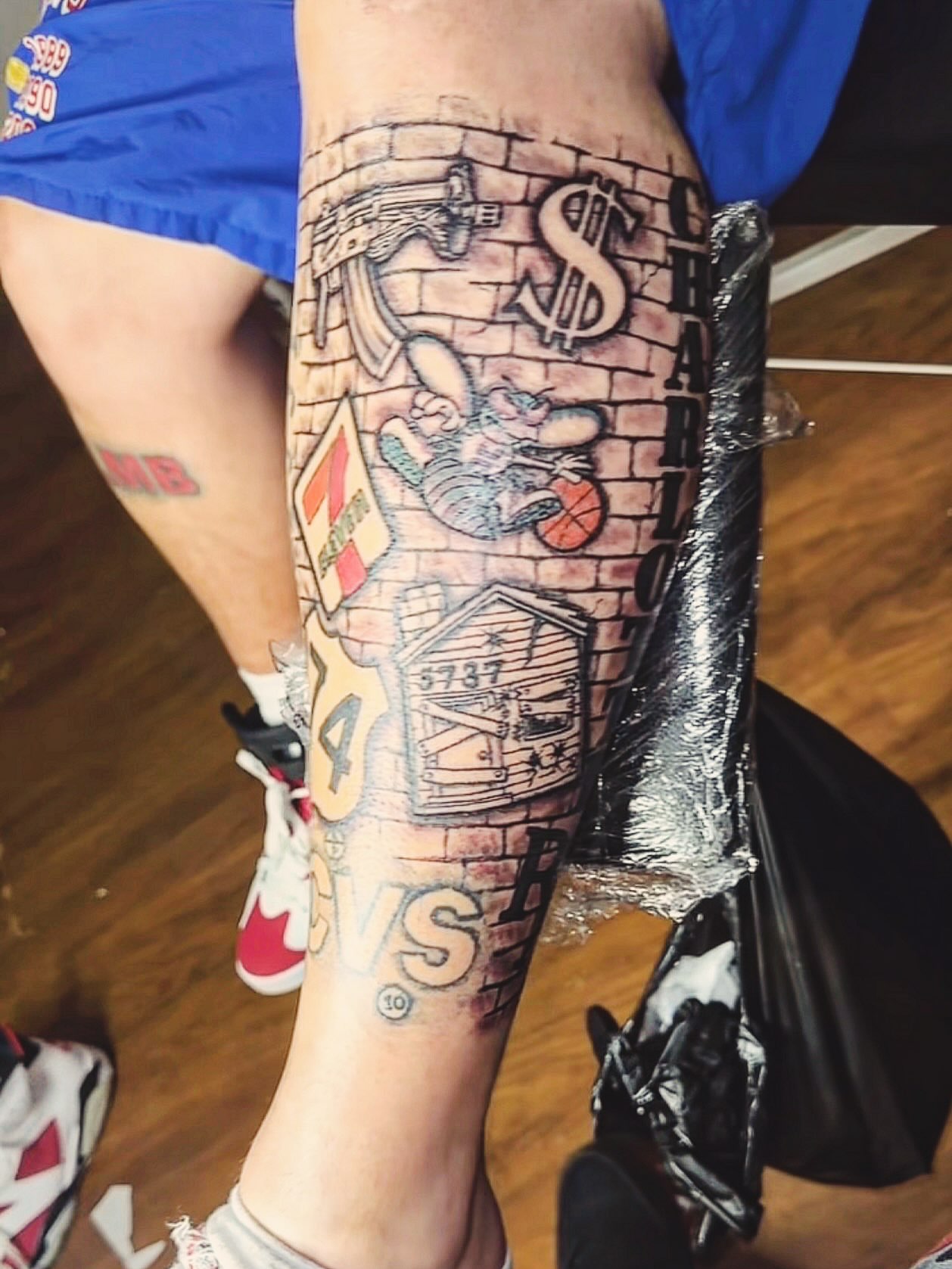 Brick wall with graffiti American traditional tattoo on the calf by Jihaad staley π¦, Charlotte, North Carolina