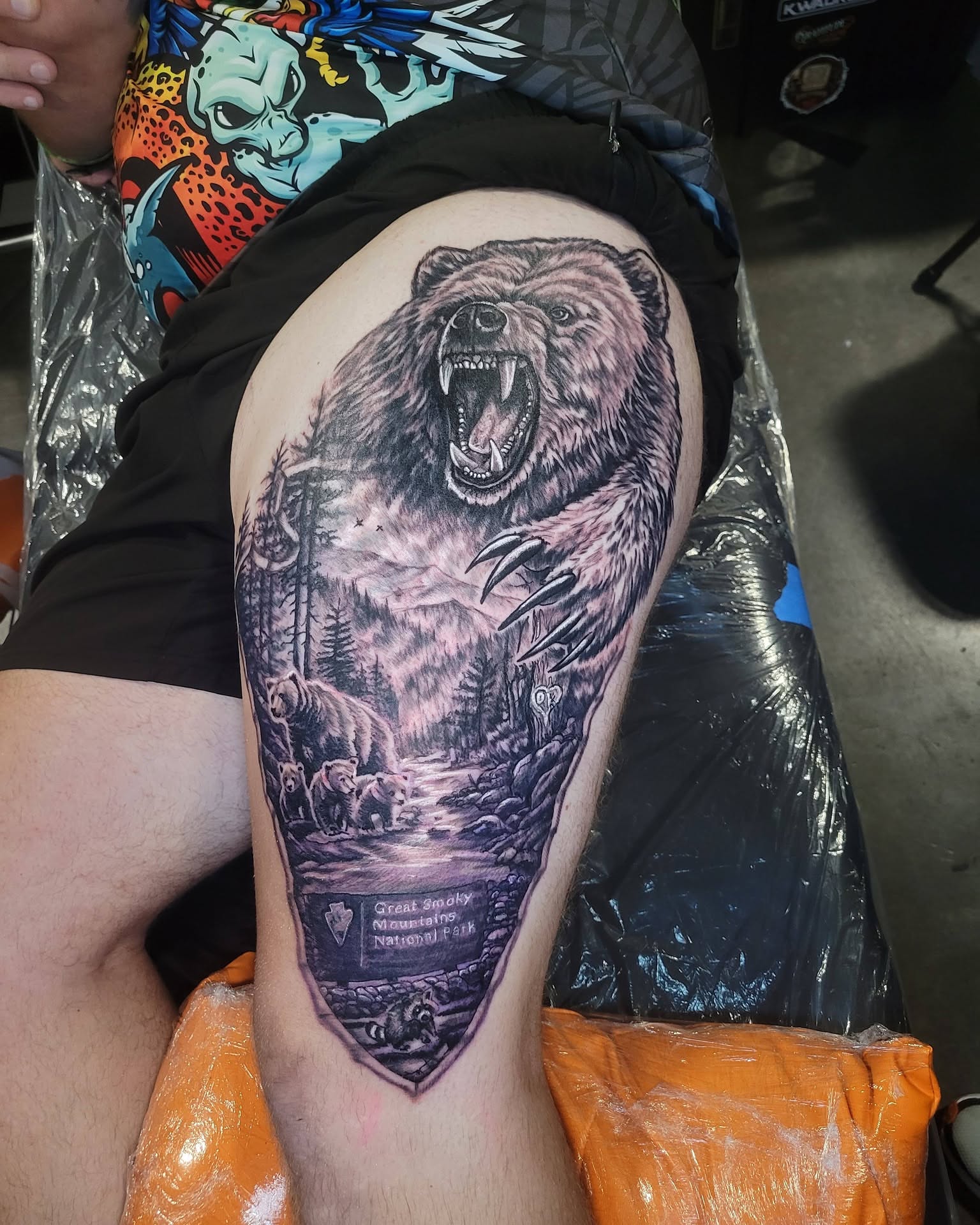 Bear and forest realism tattoo on the thigh by Danny Stewart