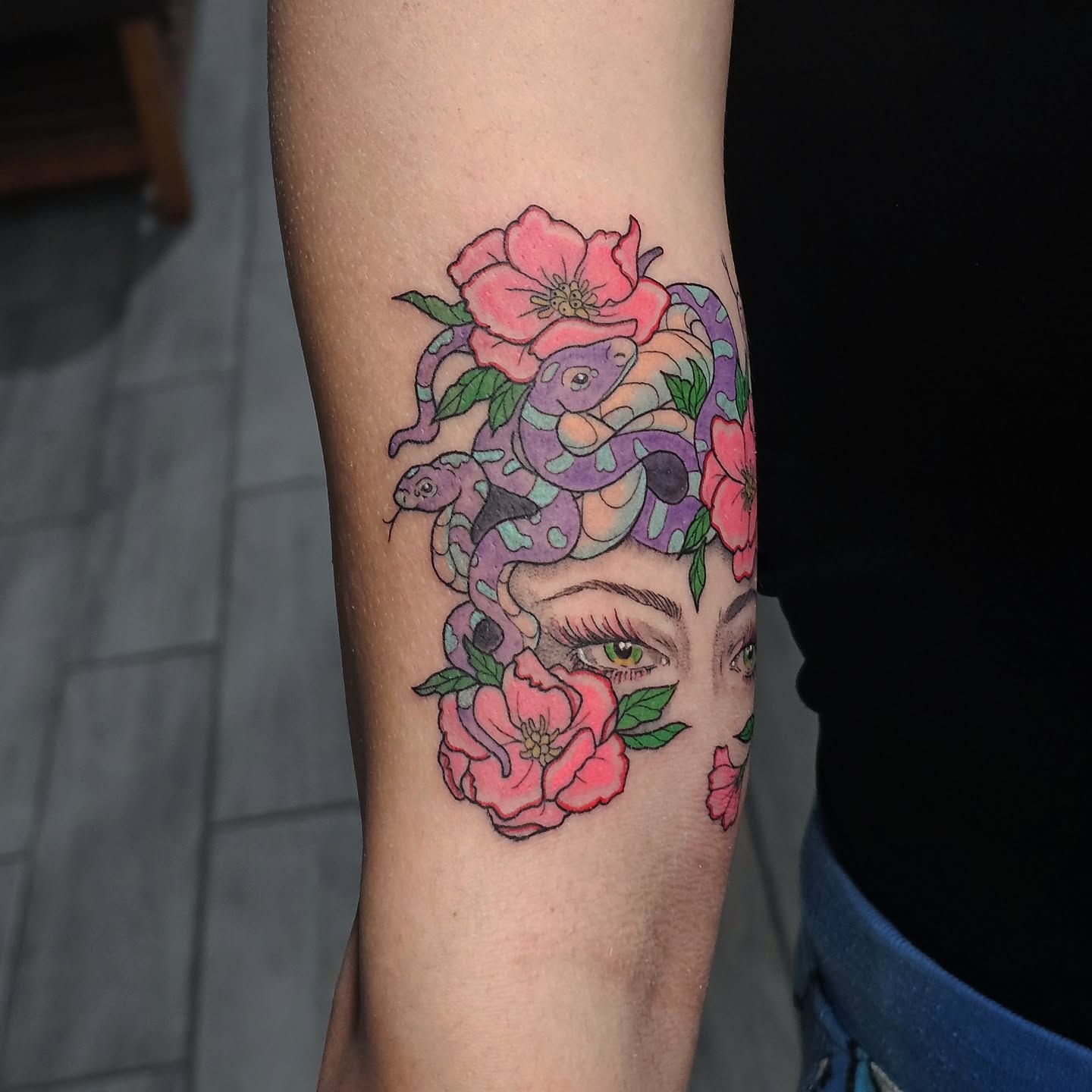 Snake and peony American traditional tattoo on the forearm by Casey Jo