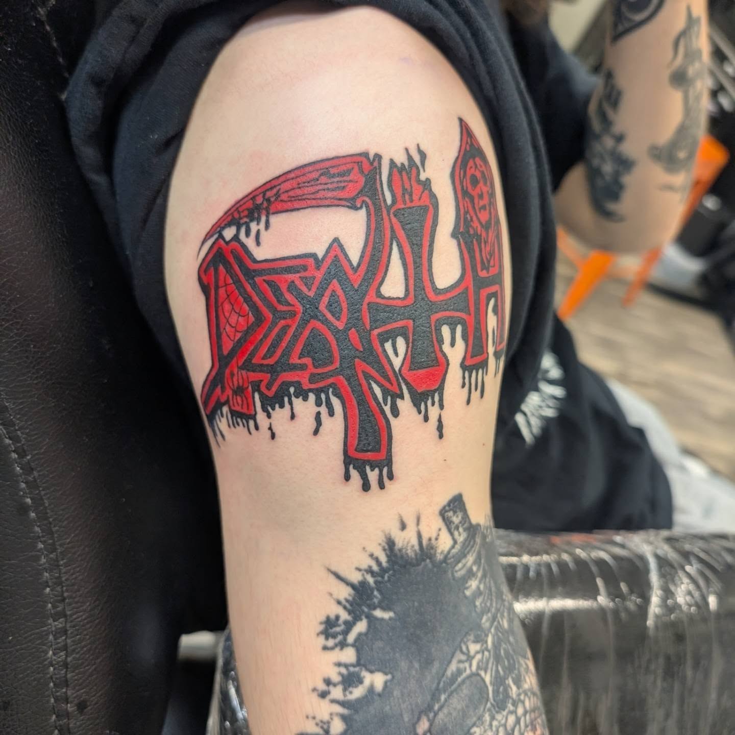 Death metal band logo lettering script tattoo on the shoulder by Talia Zula, Loveland, Ohio