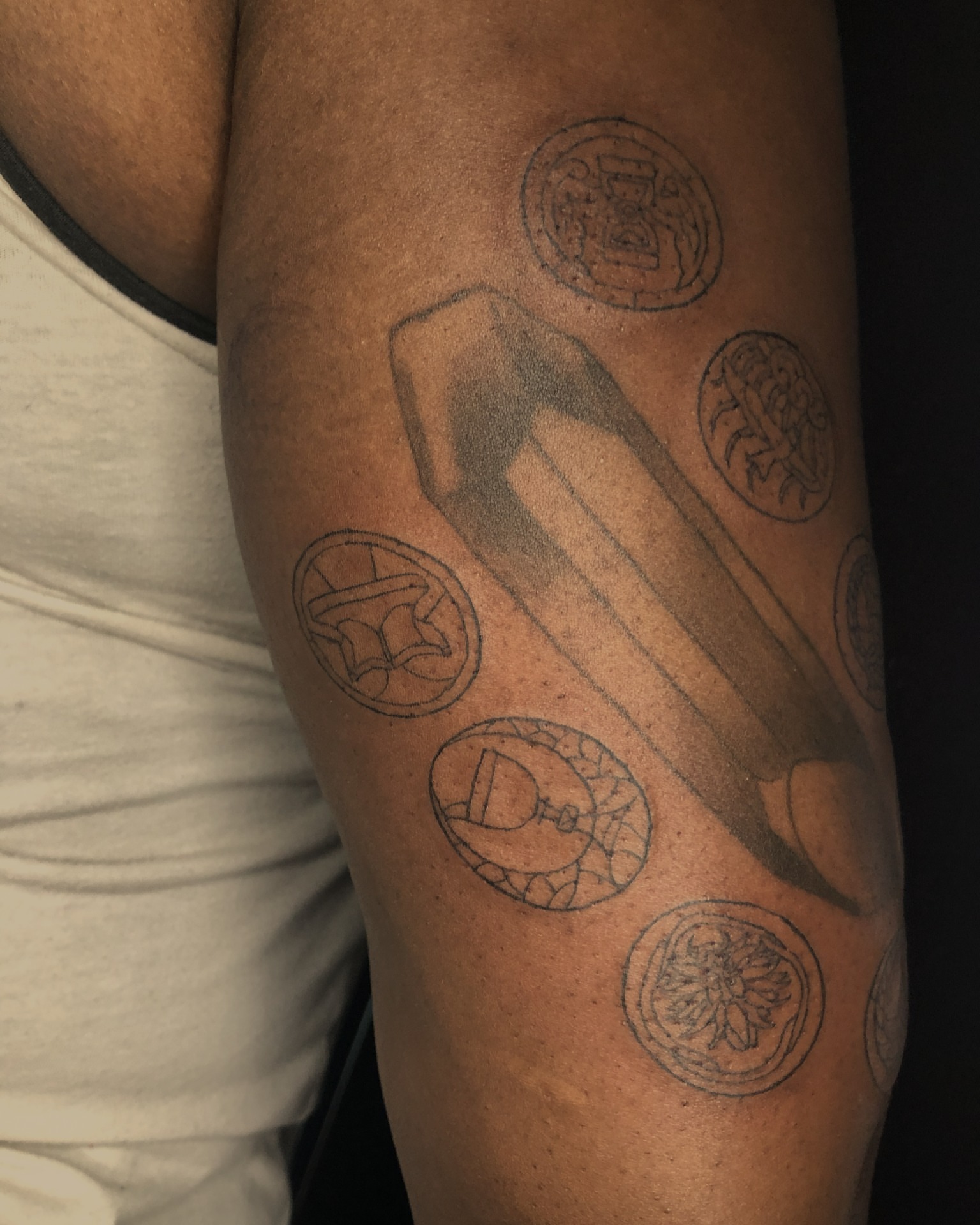 Crystal with coins black and grey tattoo on the forearm by Rowan Lee